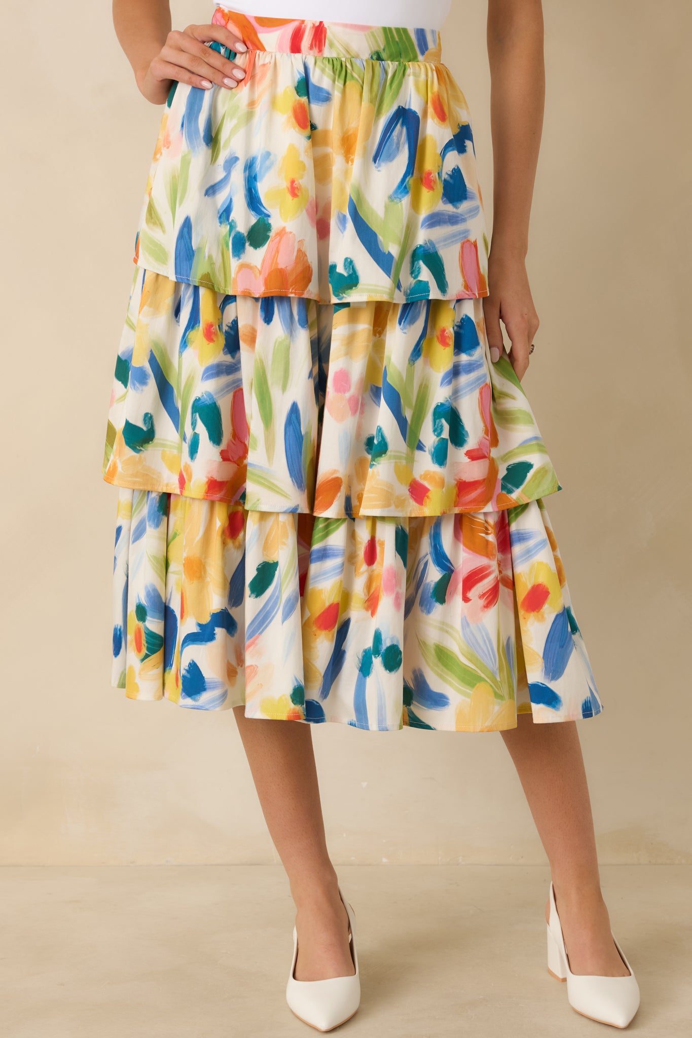 Closer view showing the flowy midi-length hem and colorful floral pattern.