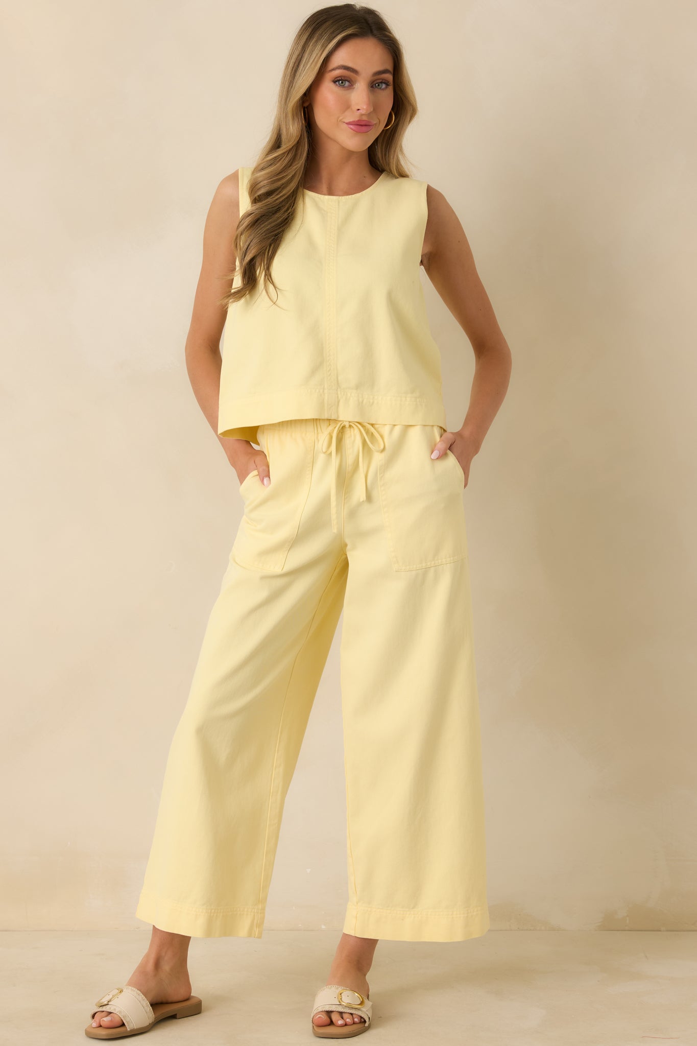 Yellow sleeveless tank with a round neckline, wide shoulder straps, and a relaxed boxy fit.