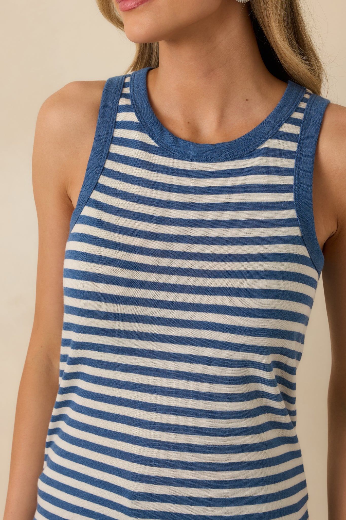 Close-up of the blue striped tank top showing the soft knit fabric and horizontal stripe detailing.