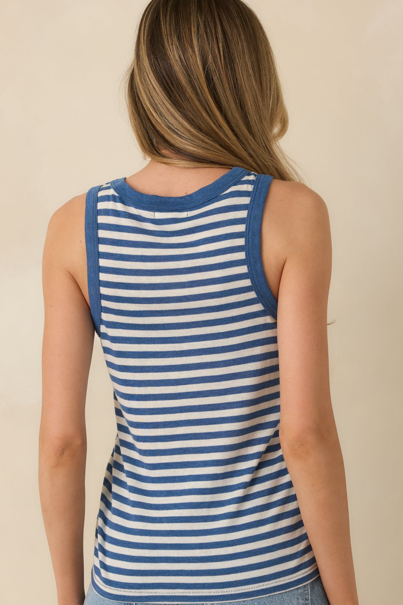 Back view of the blue striped tank top highlighting the sleeveless silhouette, scoop neckline, and smooth knit fabric.