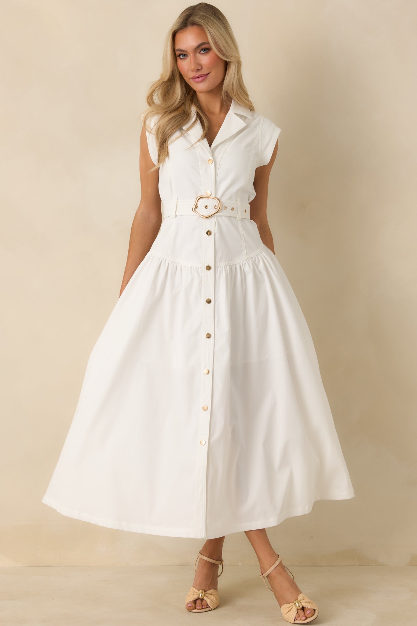 Front view of a white sleeveless maxi shirt dress with a structured collar, full button-front closure, and matching waist belt.