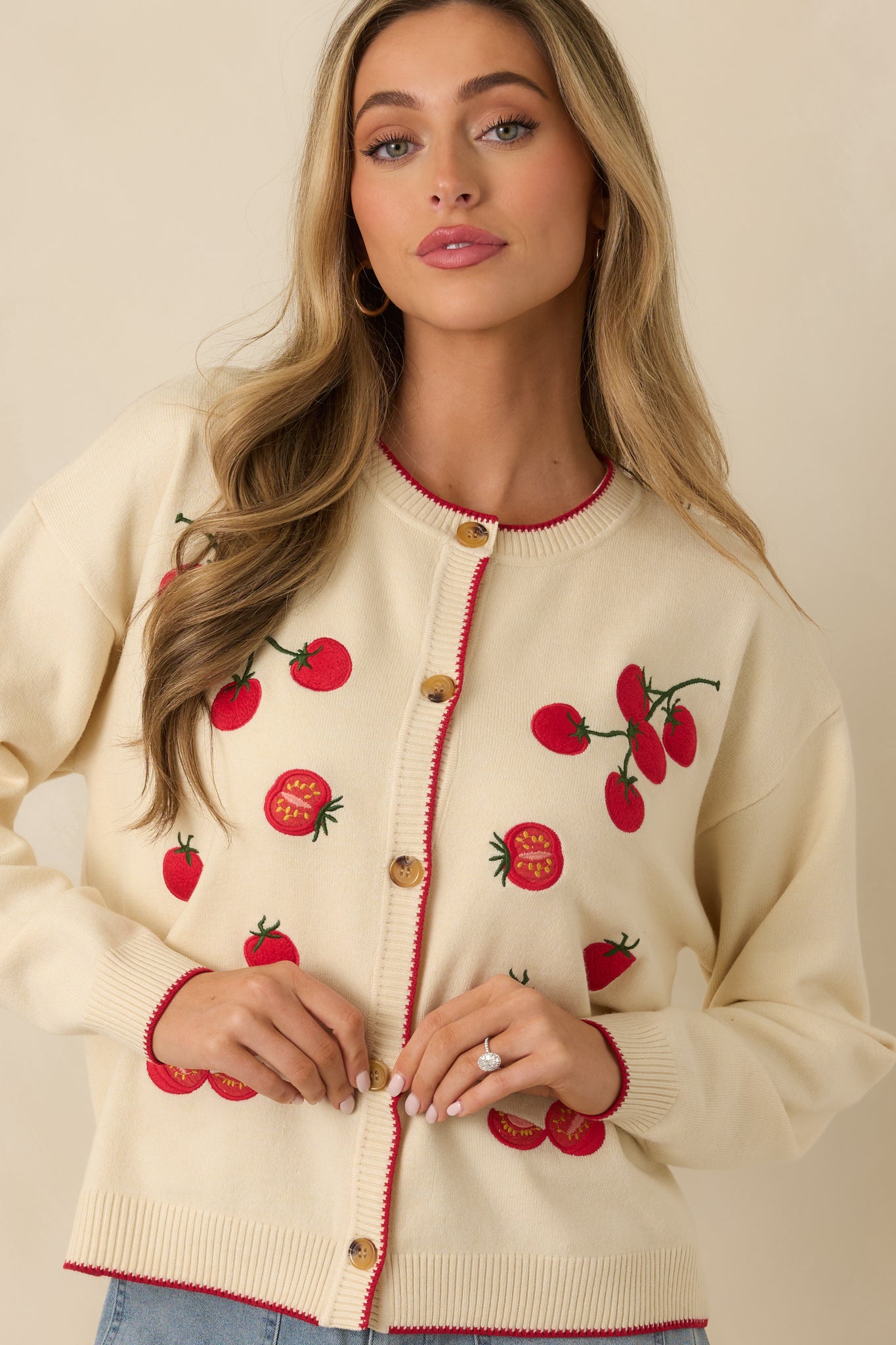 Closer view showing the long sleeves, ribbed knit texture, and relaxed drape.