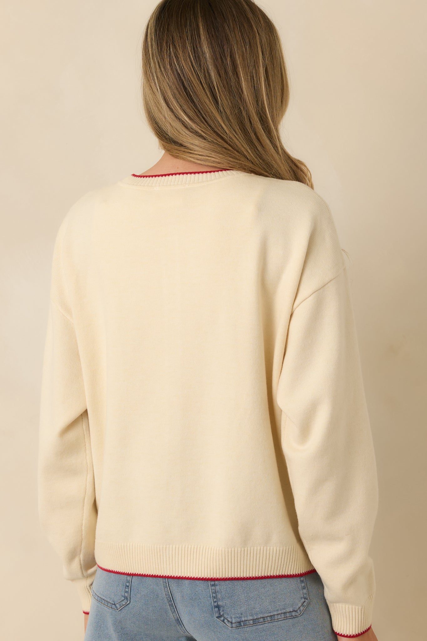 Rear view of the ivory knit cardigan showing the allover embroidered cherry tomato pattern, long sleeves, and ribbed detailing.