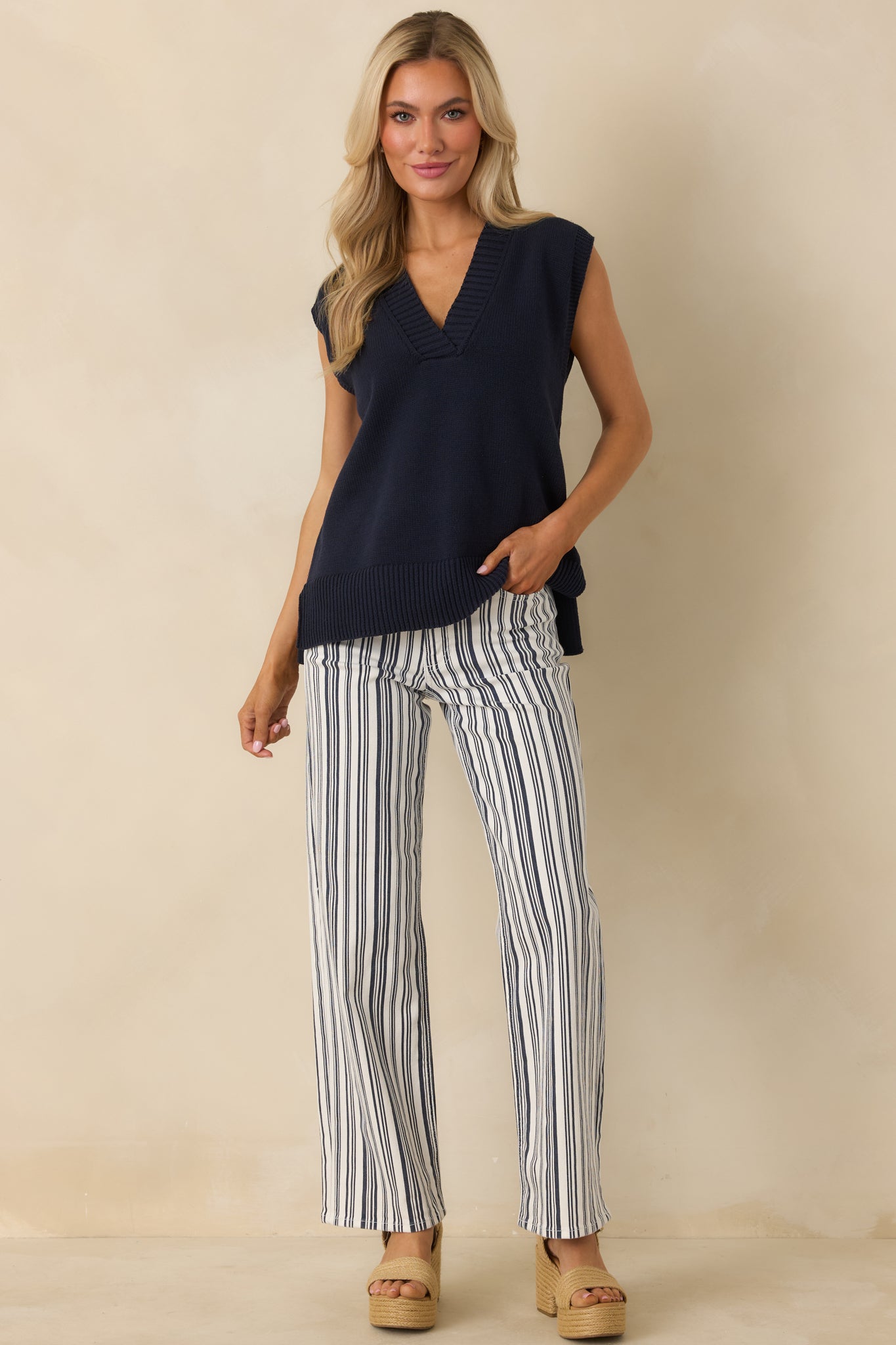 Navy cotton-blend pants featuring a vertical stripe pattern, button and zip fly closure, and belt loops for versatile styling.