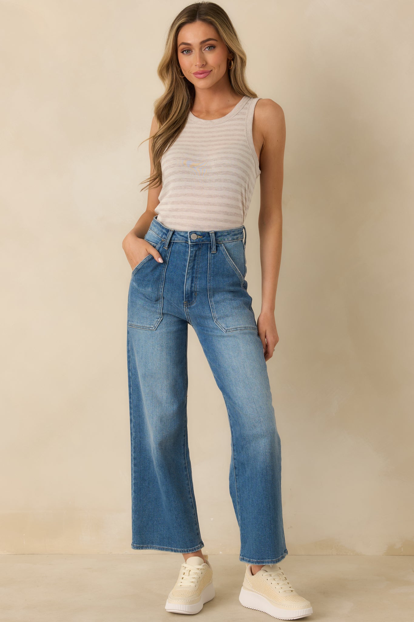 Natural heather stripe tank top with a scoop neckline, sleeveless design, and relaxed comfortable fit.