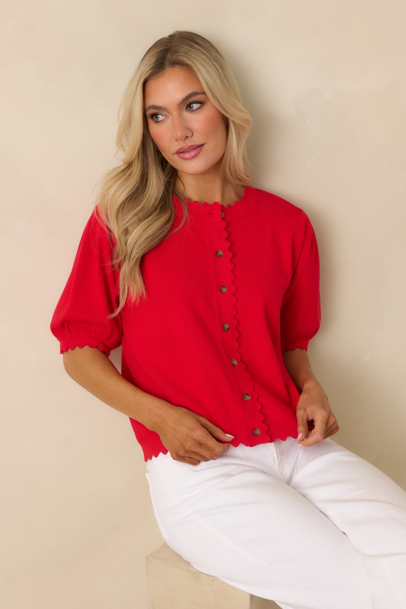Detail crop highlighting the short puff sleeve shape with scalloped edging at the sleeve opening.