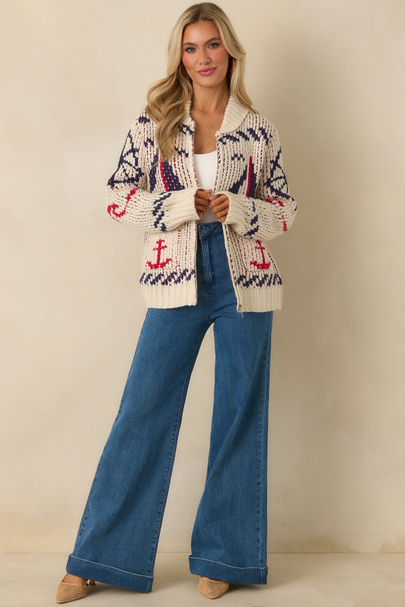 Front view of ivory multi-knit jacket with collared neckline, full zip closure, and nautical sailboat and anchor motifs.