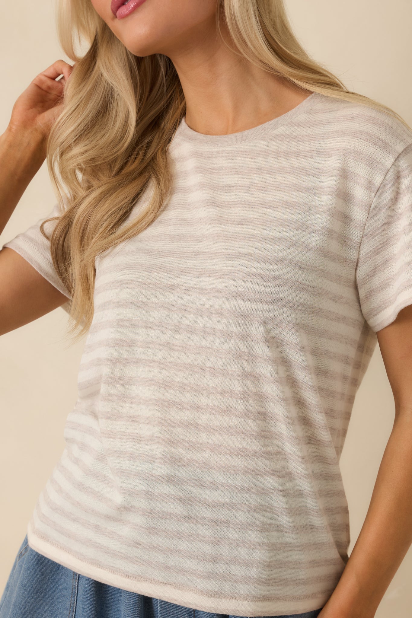 Close-up of the soft horizontal stripes and lightweight knit texture on the natural heather striped tee.