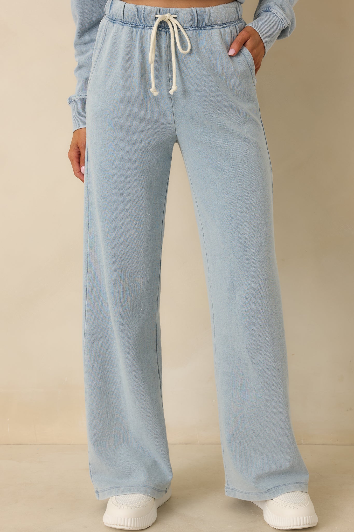 Indigo wide-leg pants showing the relaxed fit and smooth draping through the legs.