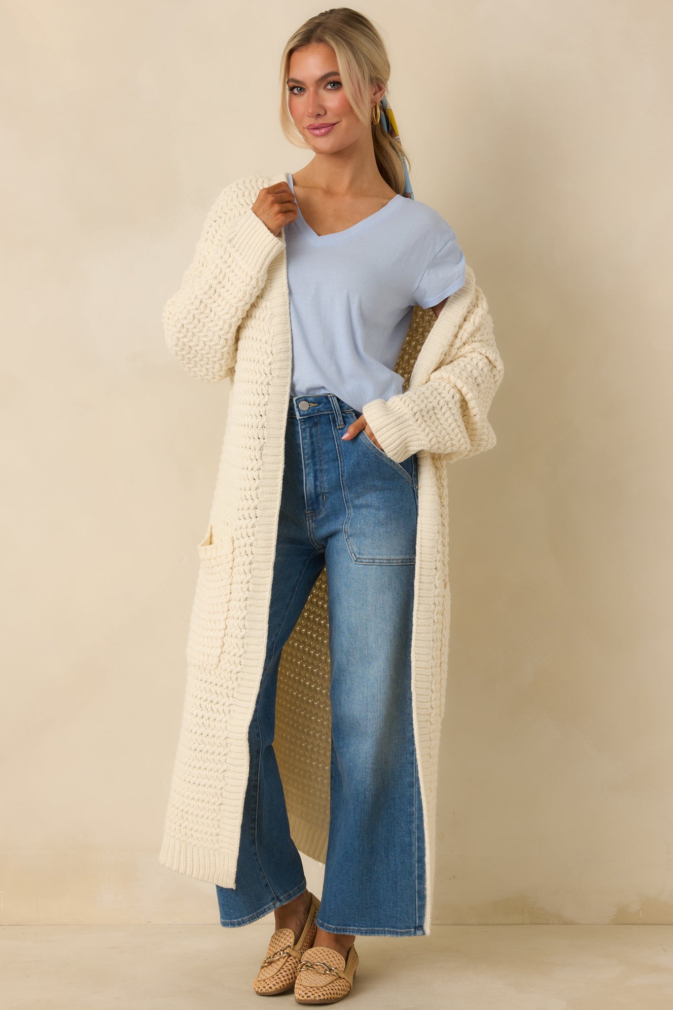 Longline cream knit cardigan with an open-front design and an easy, relaxed fit.