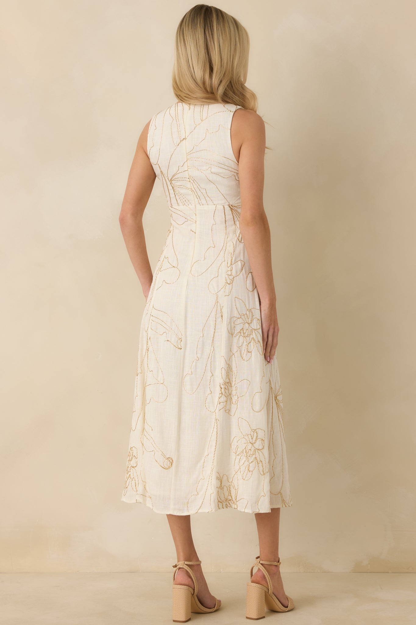 Rear view of the ivory midi dress showing the fitted bodice, flowing skirt, and concealed back zipper closure.