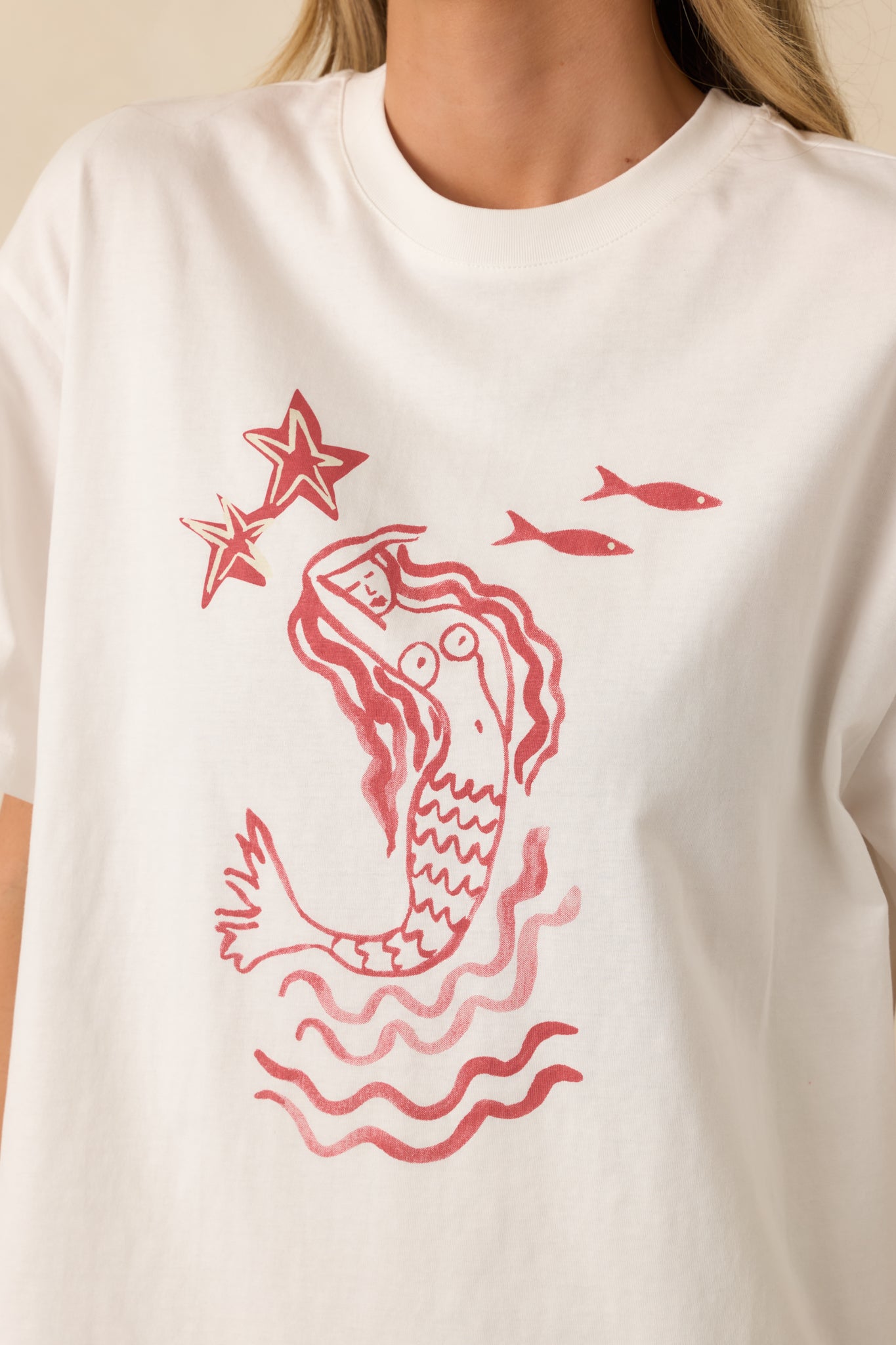 Detailed close-up of the mermaid graphic print and soft cotton jersey texture.