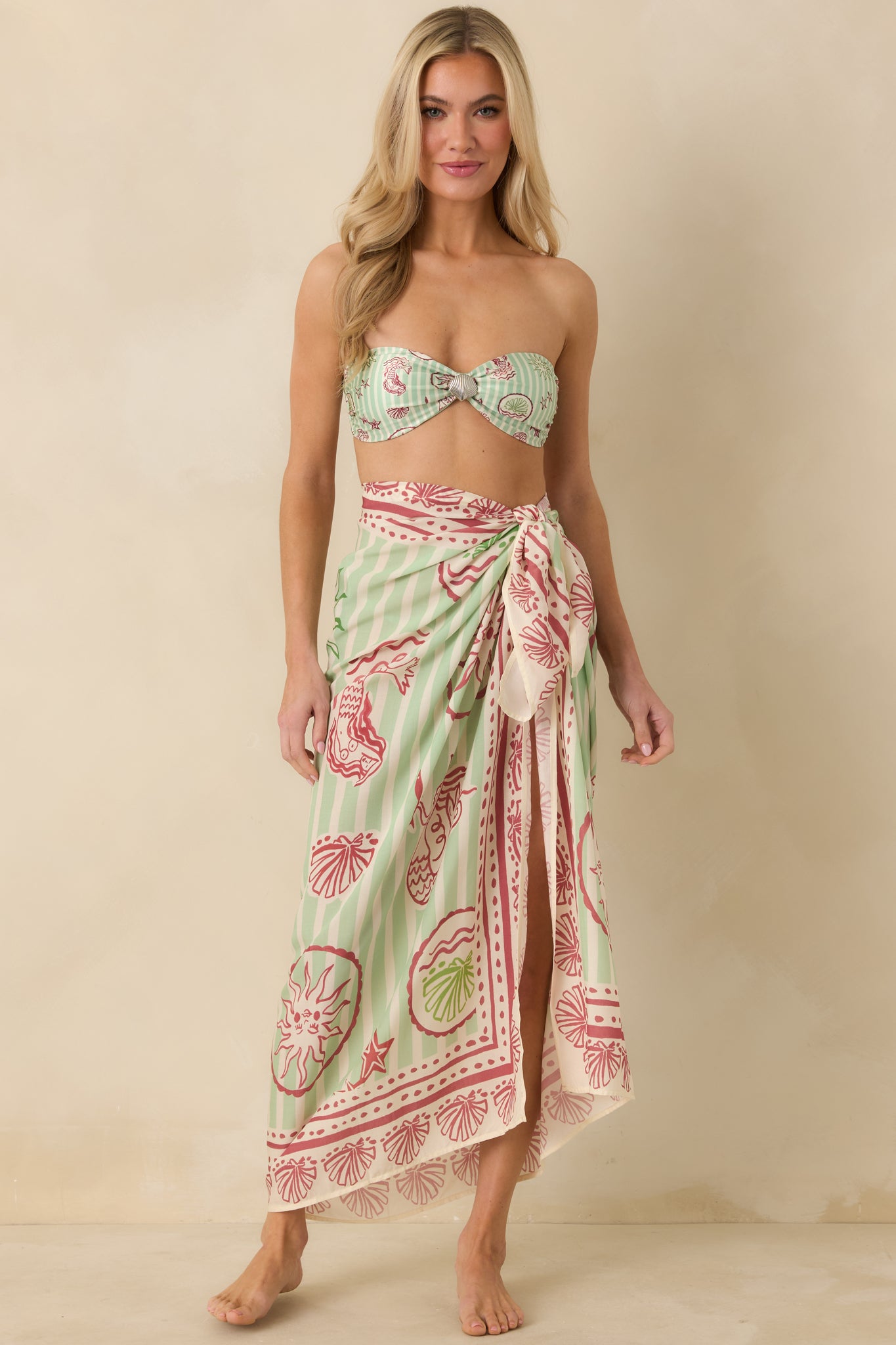 Green and pink wrap sarong showcasing allover mermaid motif and softly flowing silhouette.