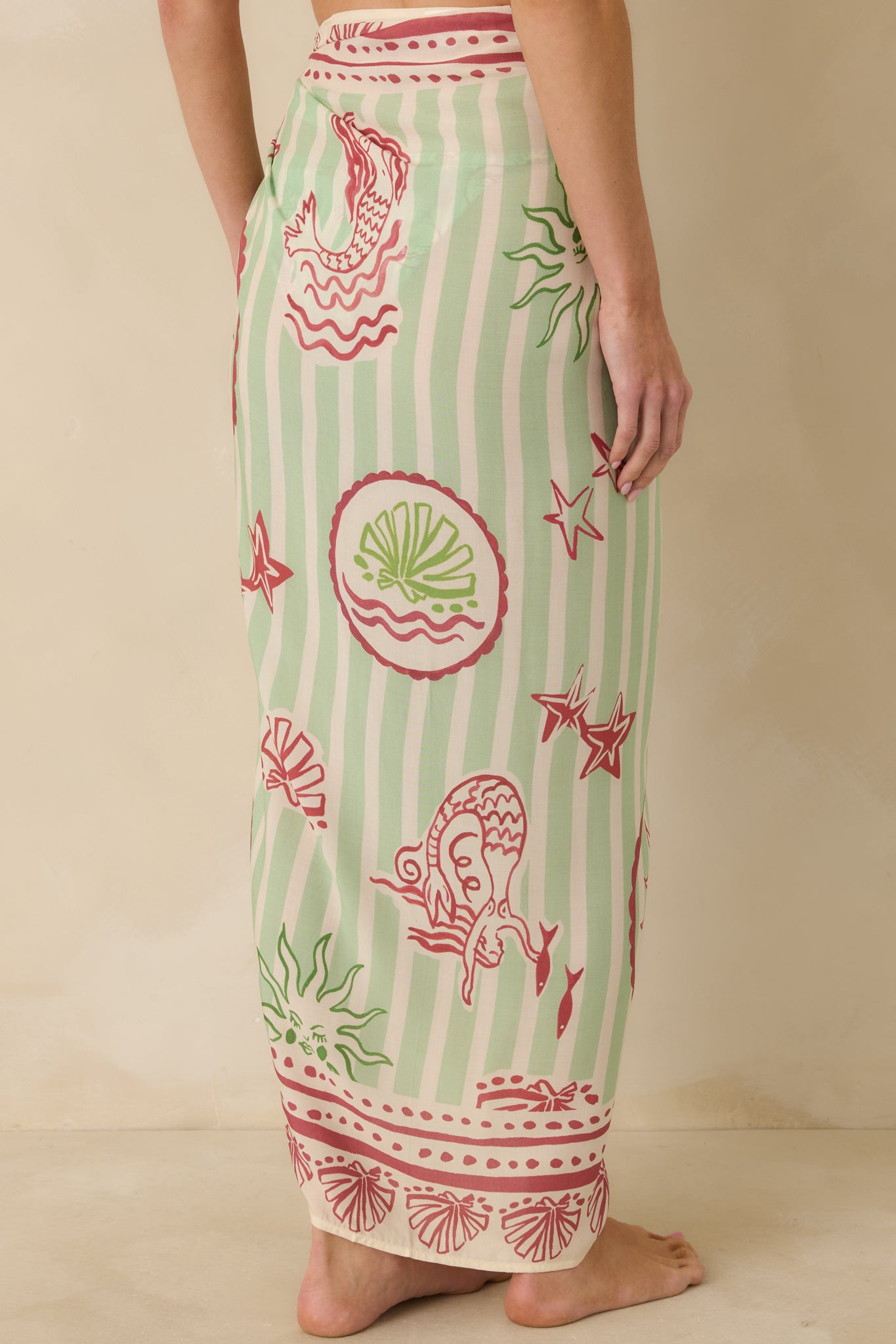 Back view of green and pink wrap sarong showing adjustable tie closure and softly draped skirt.