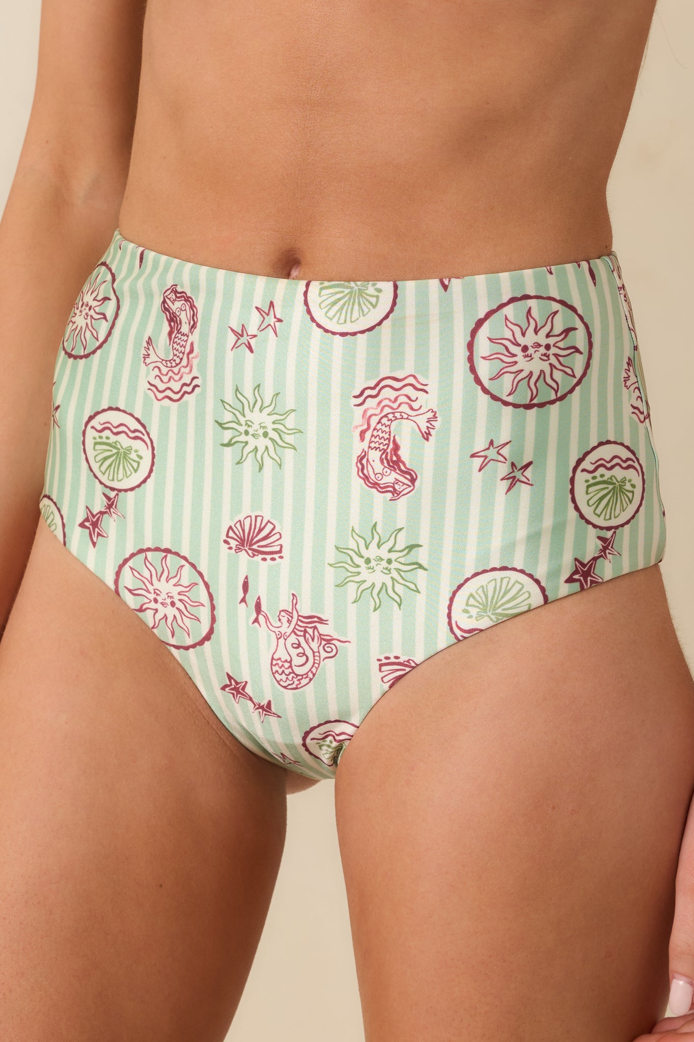 Detailed close-up of the green stripe fabric and pink coastal-inspired print pattern.