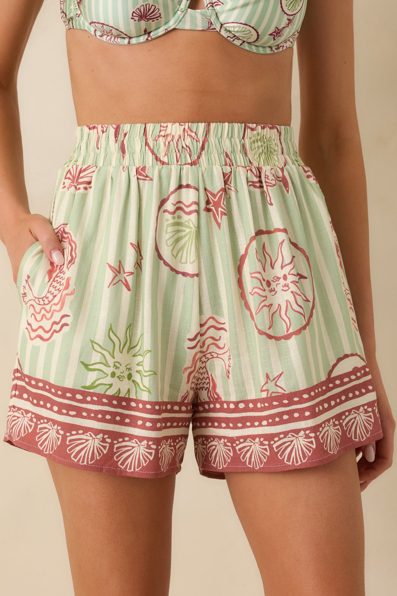 Detailed close-up of the pink mermaid print, striped fabric, and hem border stitching.