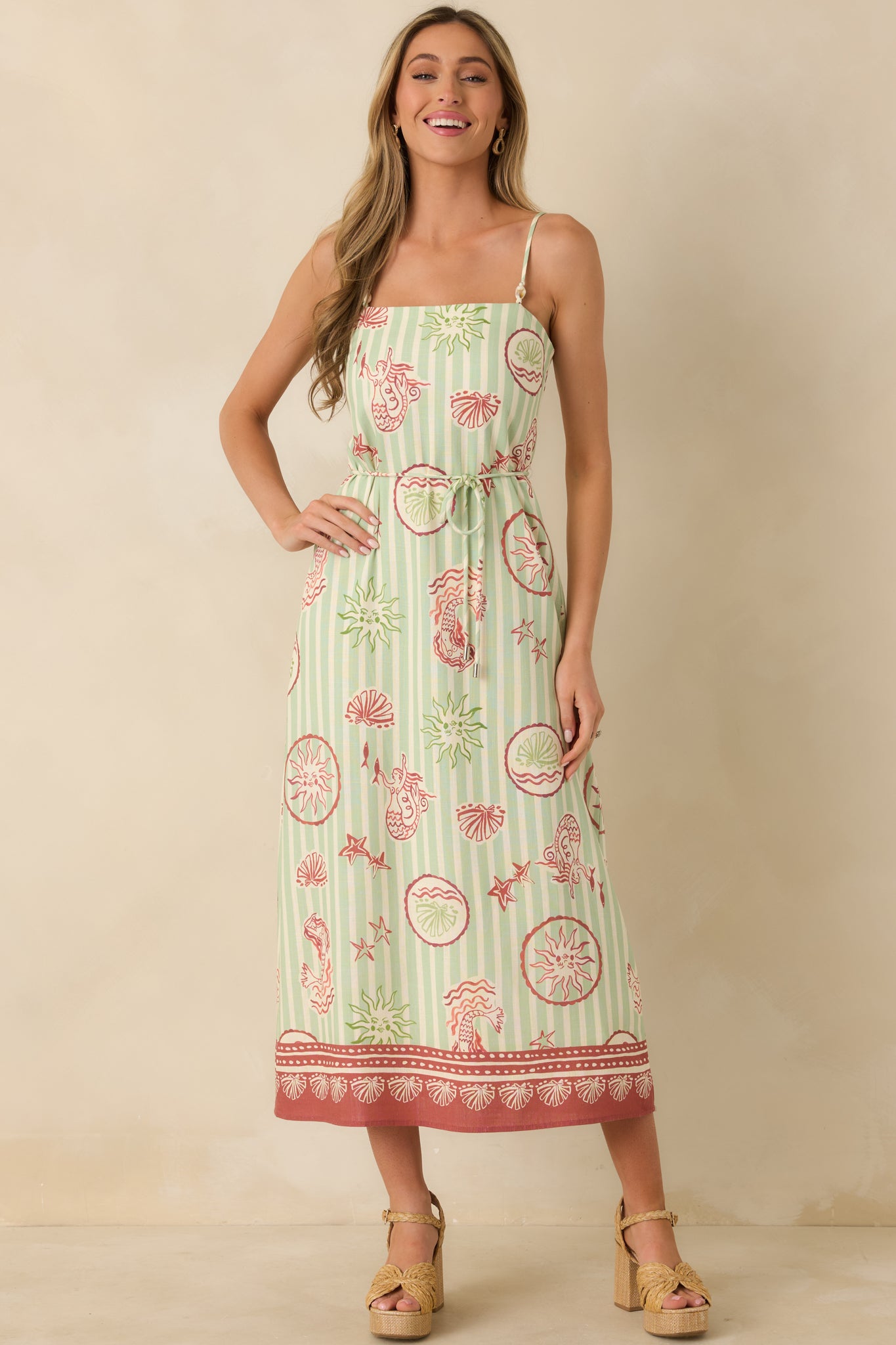 Green stripe midi dress with adjustable spaghetti straps, straight neckline, and whimsical pink seaside print.