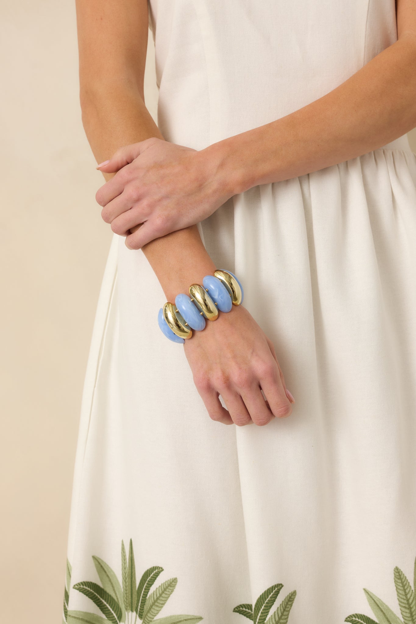 Blue and gold statement bracelet featuring alternating smooth blue beads and shiny gold beads on dual stretch bands.