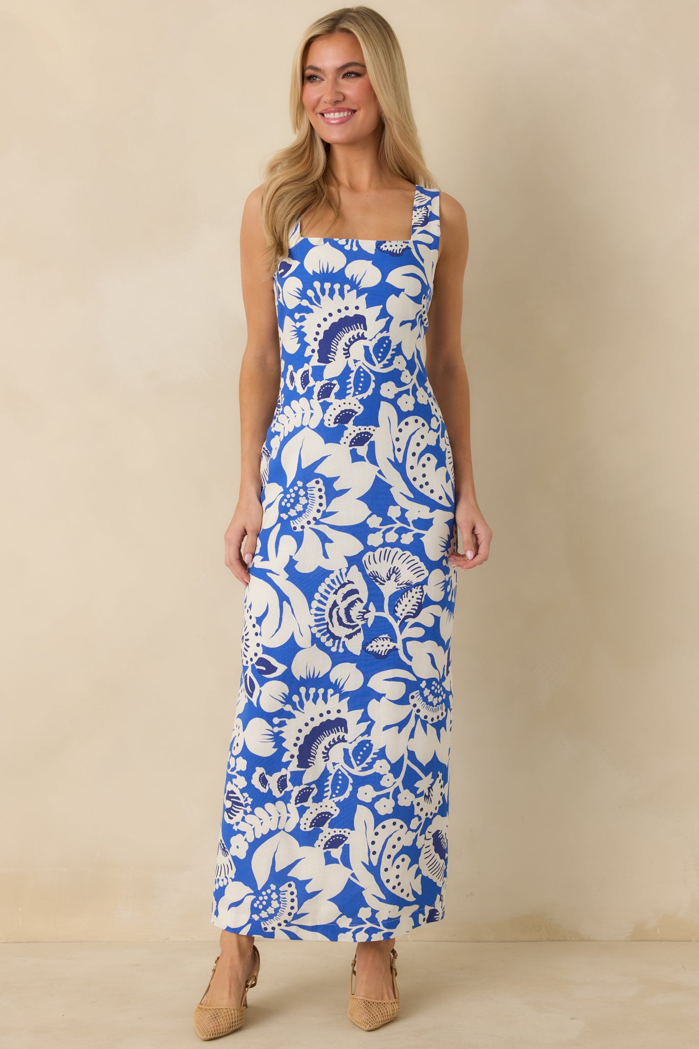 Sleeveless maxi dress in blue and white with wide shoulder straps, squared neckline, and breathable lightweight fabric.