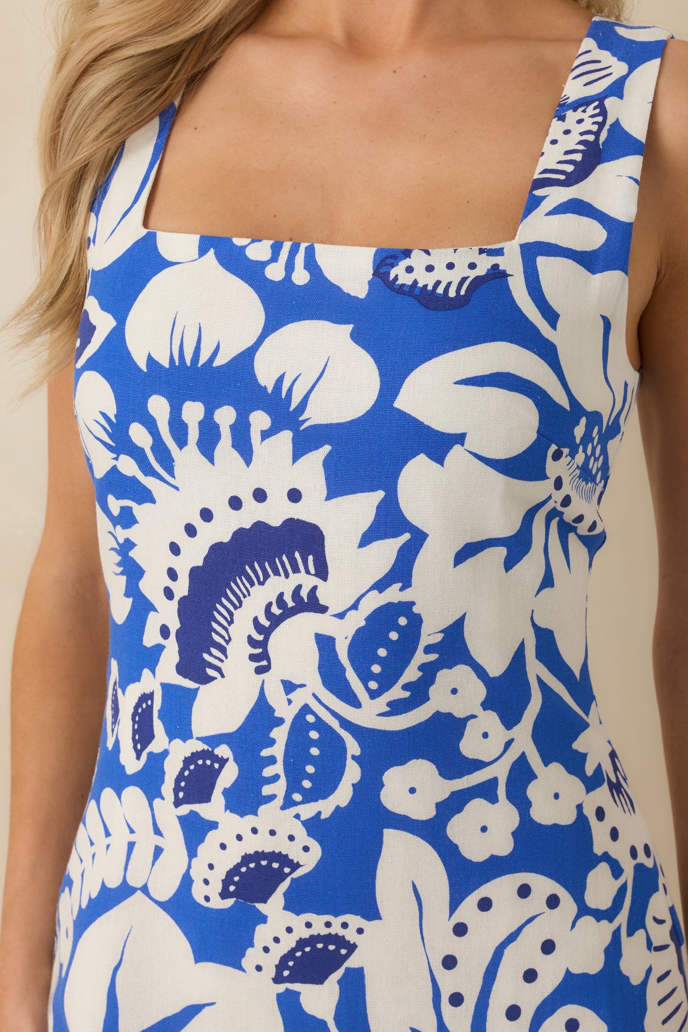 Detailed look at the linen-blend fabric, squared neckline, wide shoulder straps, and smooth inner lining.