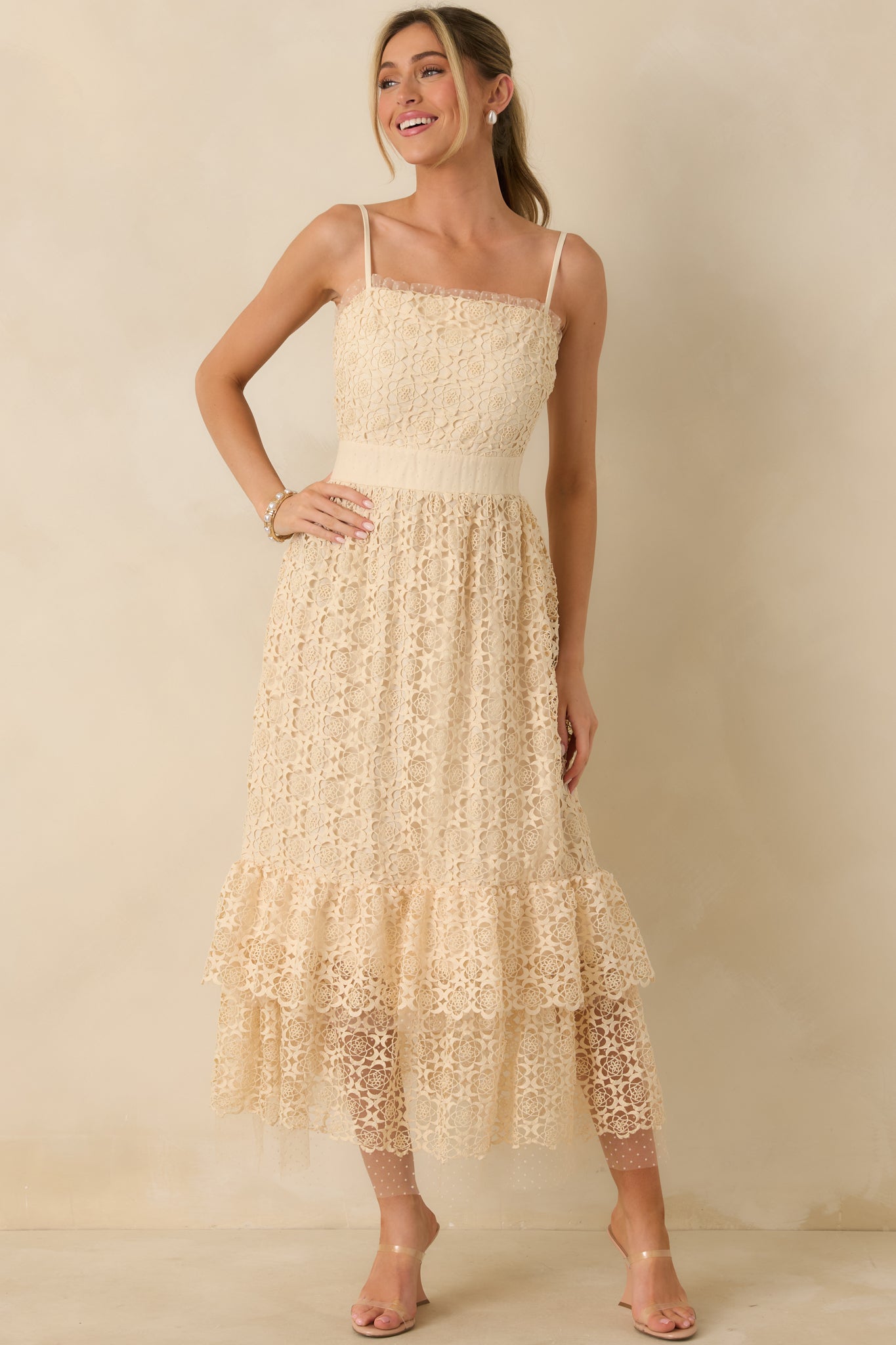 Front view of natural midi dress highlighting adjustable spaghetti straps and embroidered design throughout.