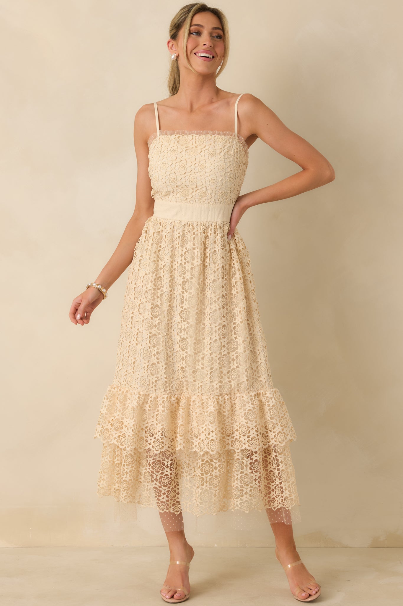 Three-quarter front angle emphasizing lace polka dot ruffles along the trim and flowing silhouette.