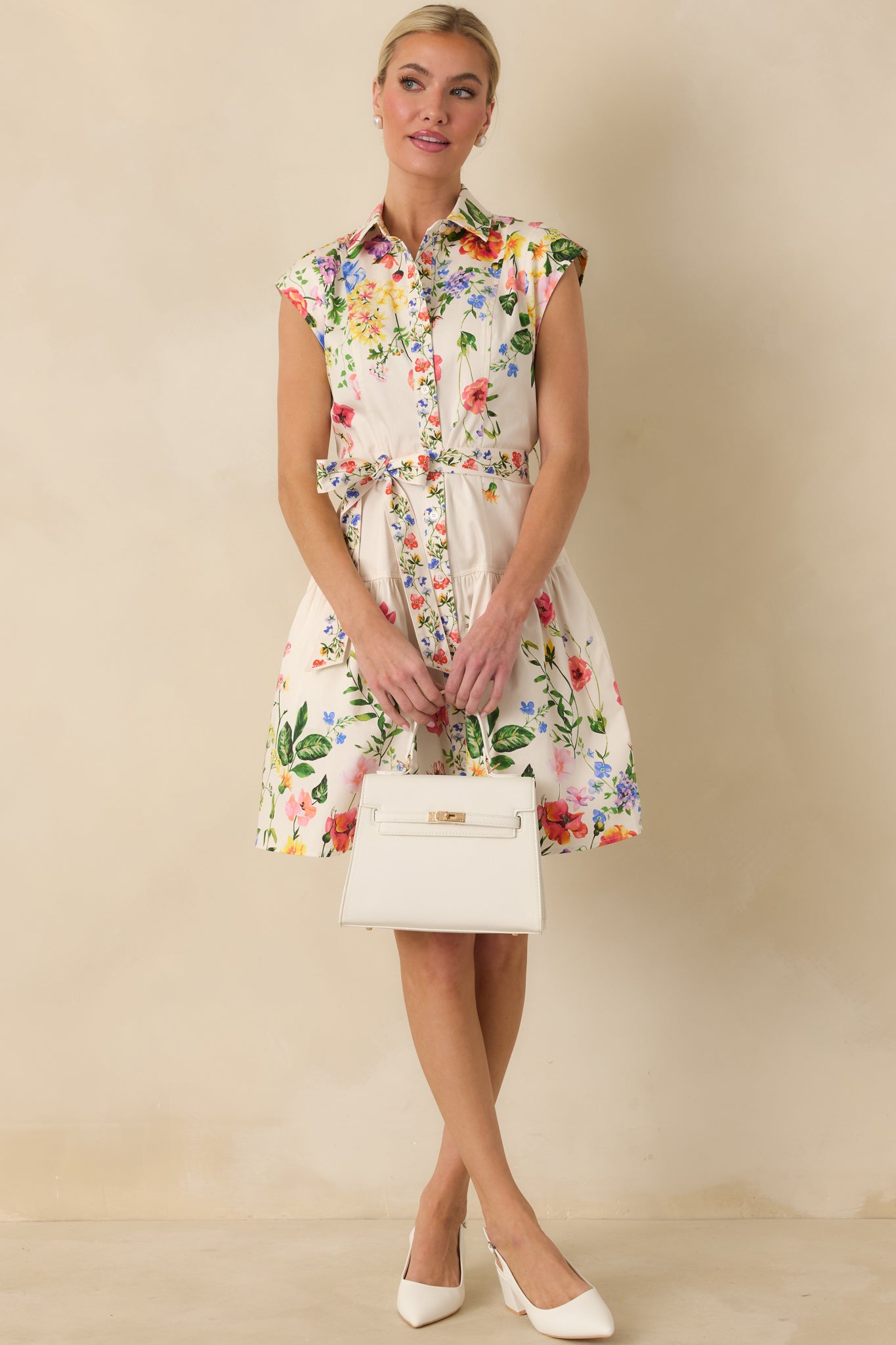 Multi floral mini dress with button-front closure, cap sleeves, and gently flared silhouette.