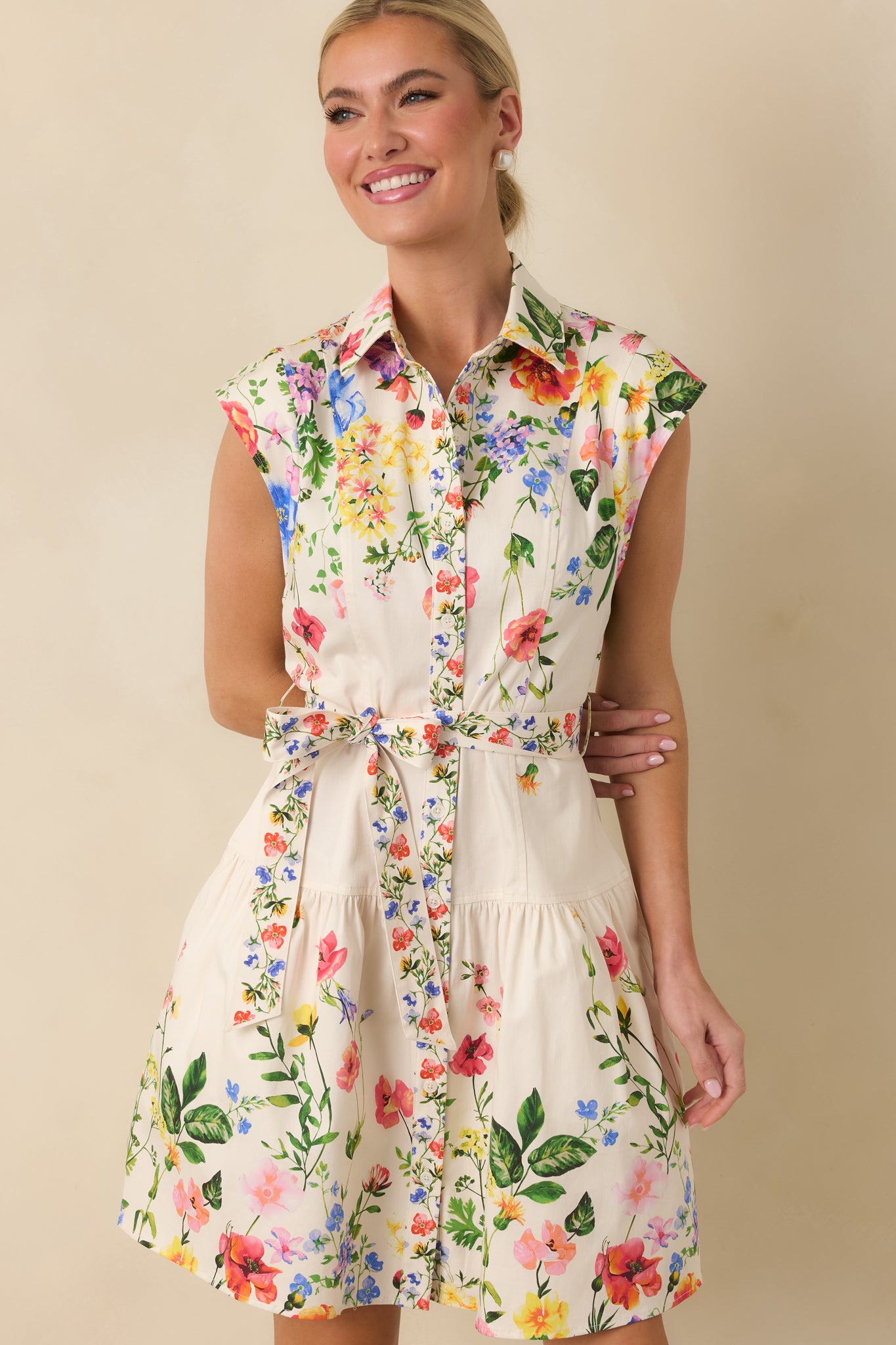 Softly flared skirt and lightweight floral print fabric of the white mini dress.