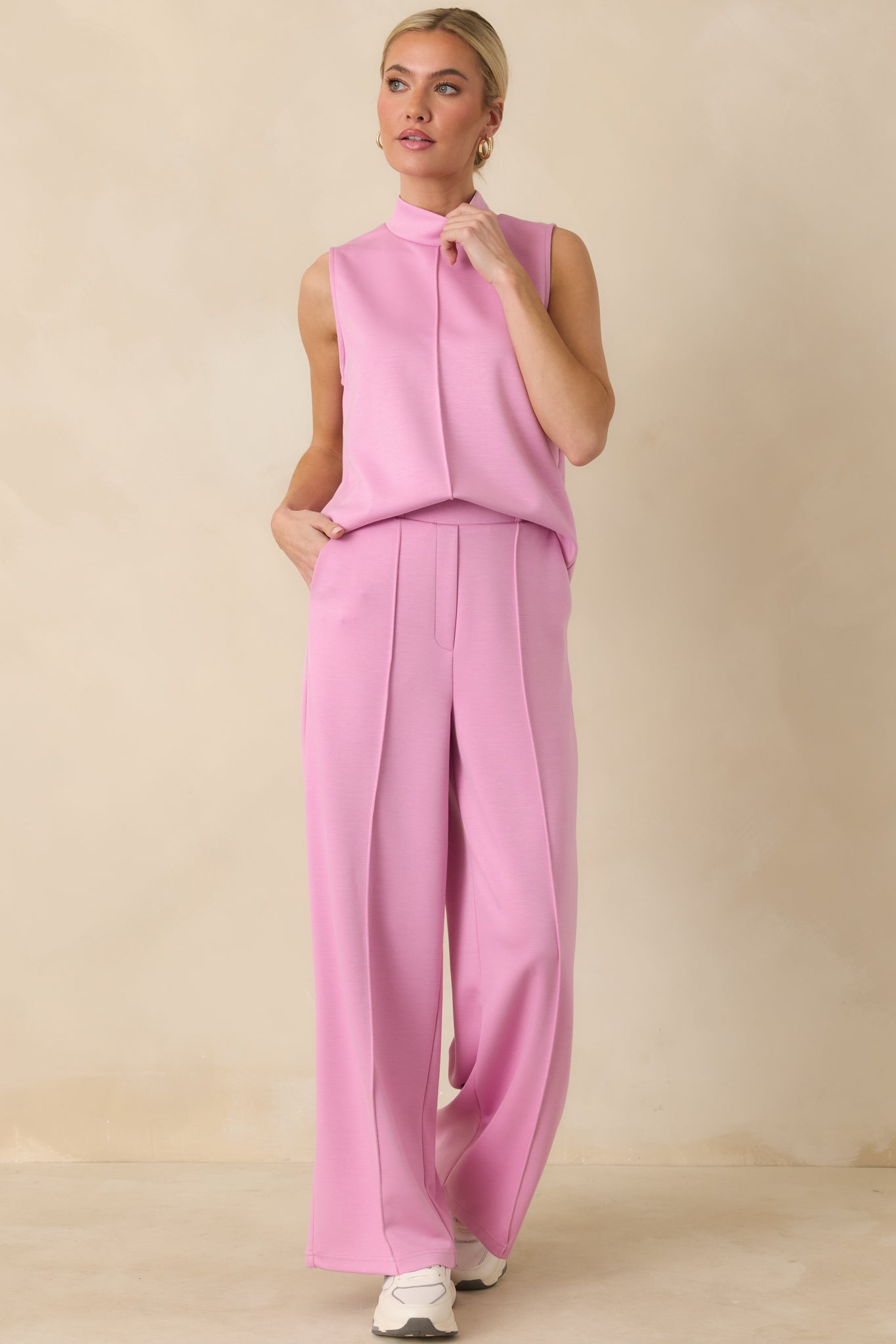 Pink tank top designed with a minimalist shape, sleeveless cut, and easy drape through the body.