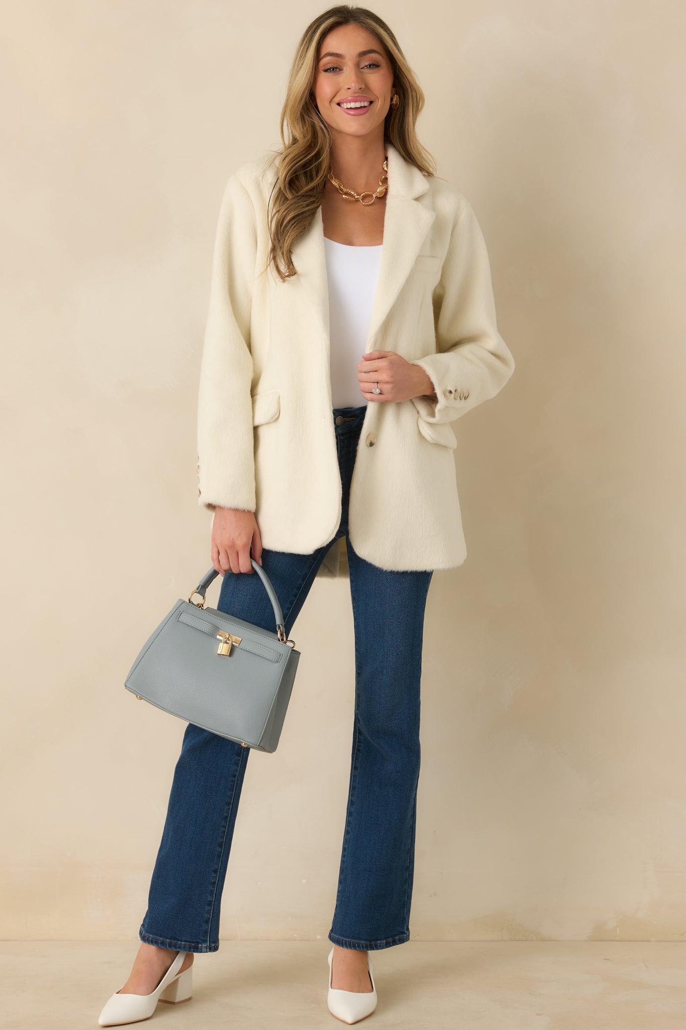 Ivory felted blazer with open-front design, relaxed fit, and tailored shape.