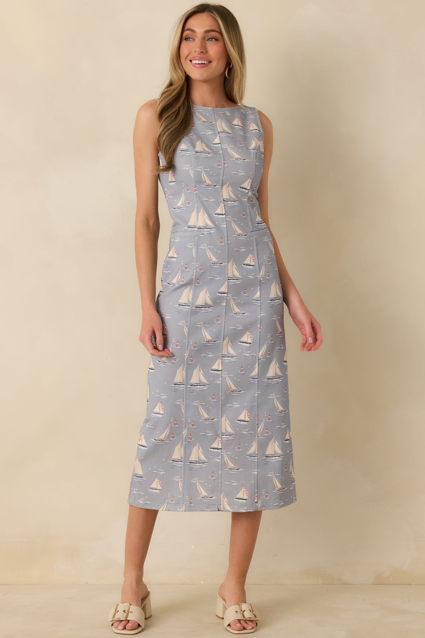 Sleeveless dusty blue midi dress highlighting the allover sailboat print and comfortable, relaxed fit.