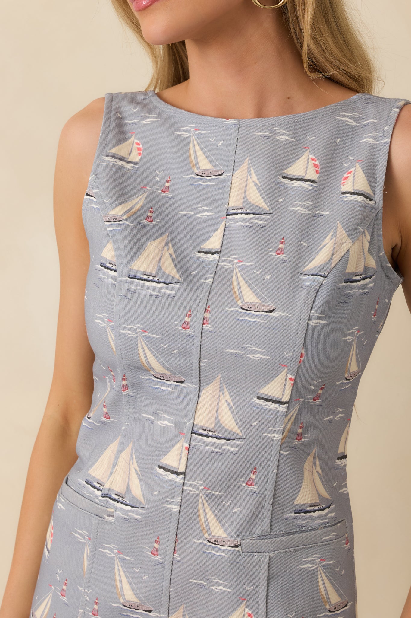 Detailed view of dusty blue midi dress showing the sailboat print, round neckline, and soft cotton-blend fabric texture.