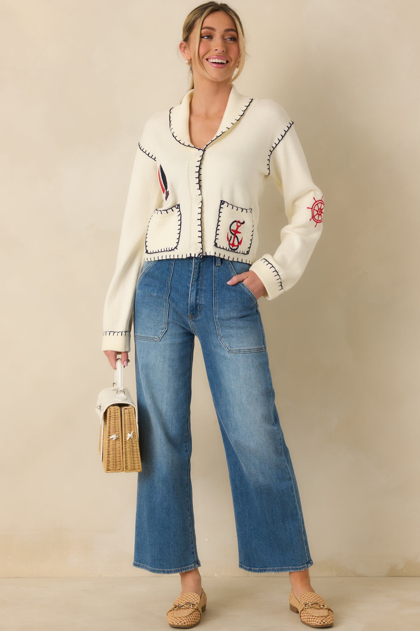Relaxed-fit ivory cardigan highlighting long sleeves, open front, and subtle contrast whipstitch accents throughout.