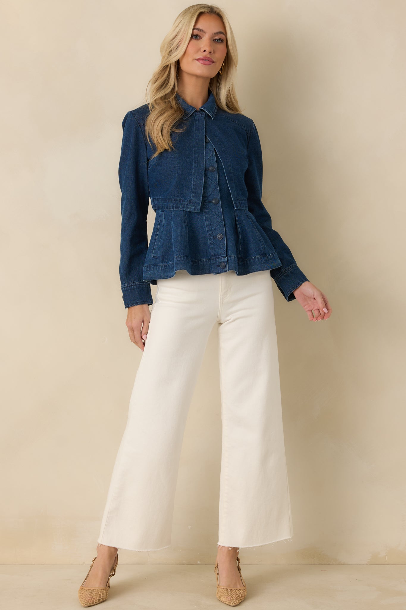 Dark wash cotton denim cropped jacket with a collared neckline, long sleeves, and a structured silhouette designed for layered styling.