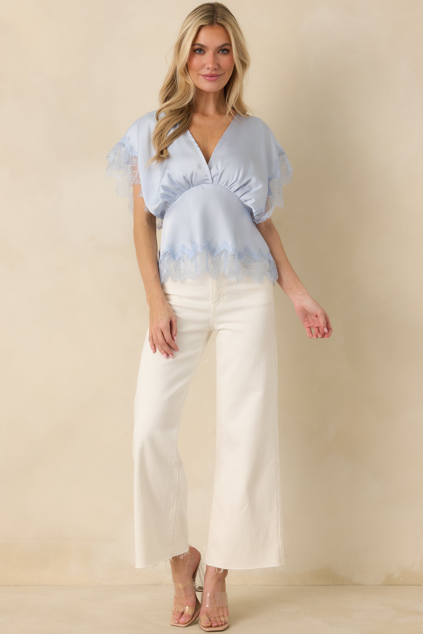 Front-facing view highlighting the blouse’s V-neck and scalloped lace hem, showing its easy, elegant fit.