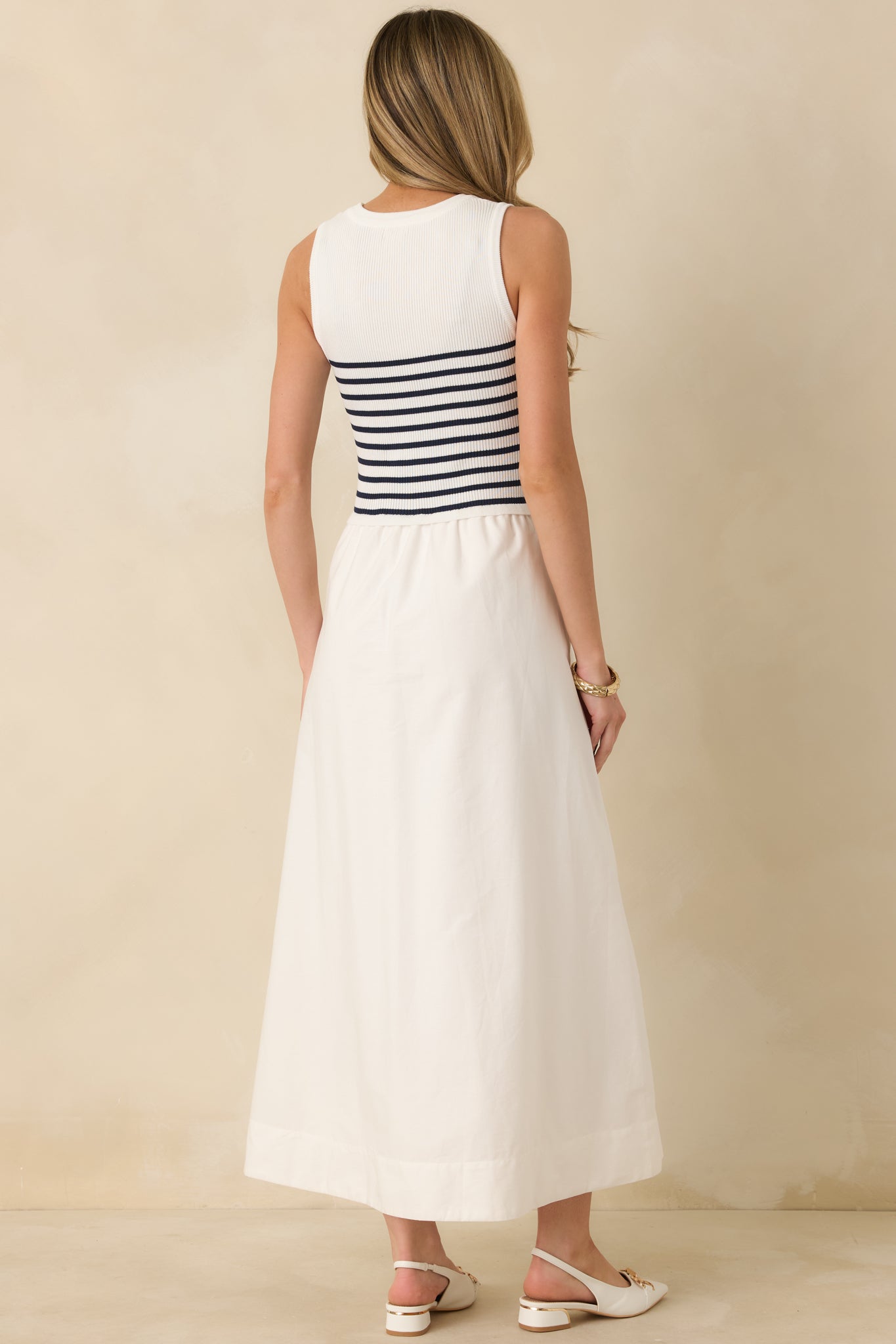 Rear view of white stripe dress showing fitted silhouette and clean construction through the back.