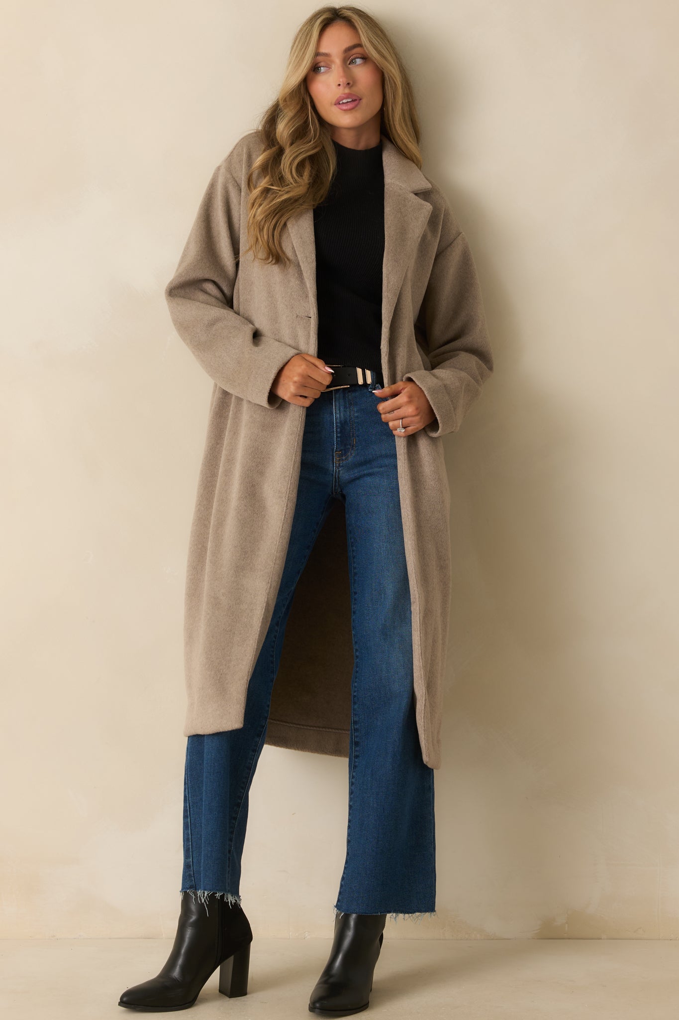 Full body front view capturing the drape and length of the coat.