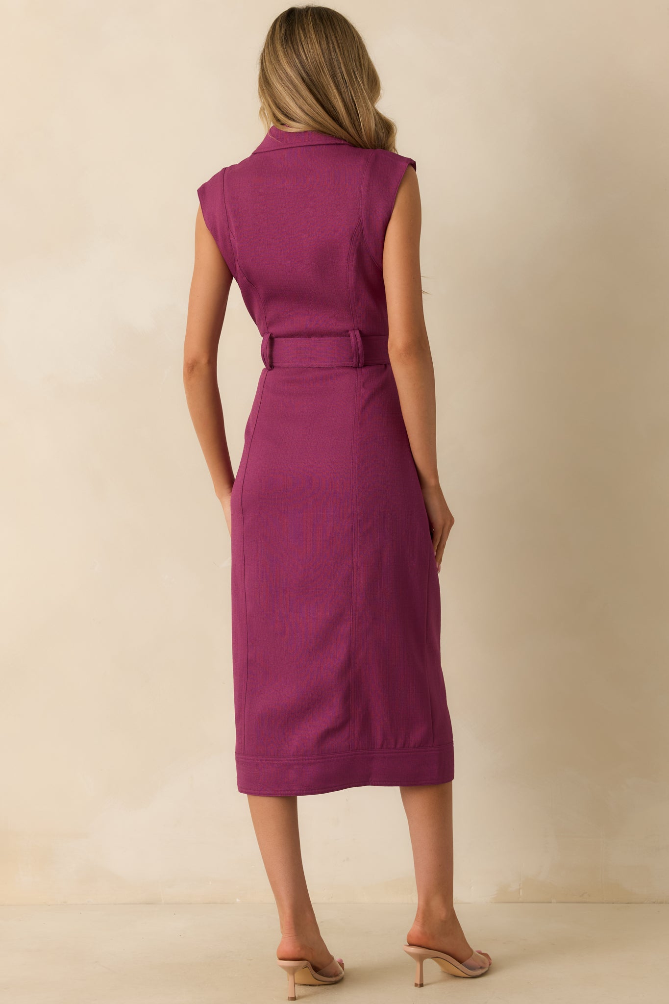 Rear view of the plum wine midi dress showing the smooth flow of the fabric and belted waistline.