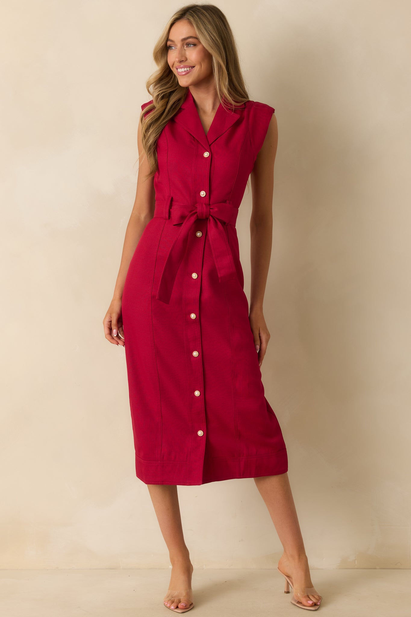 Elegant red midi dress showing the structured collar and classic button-down front.