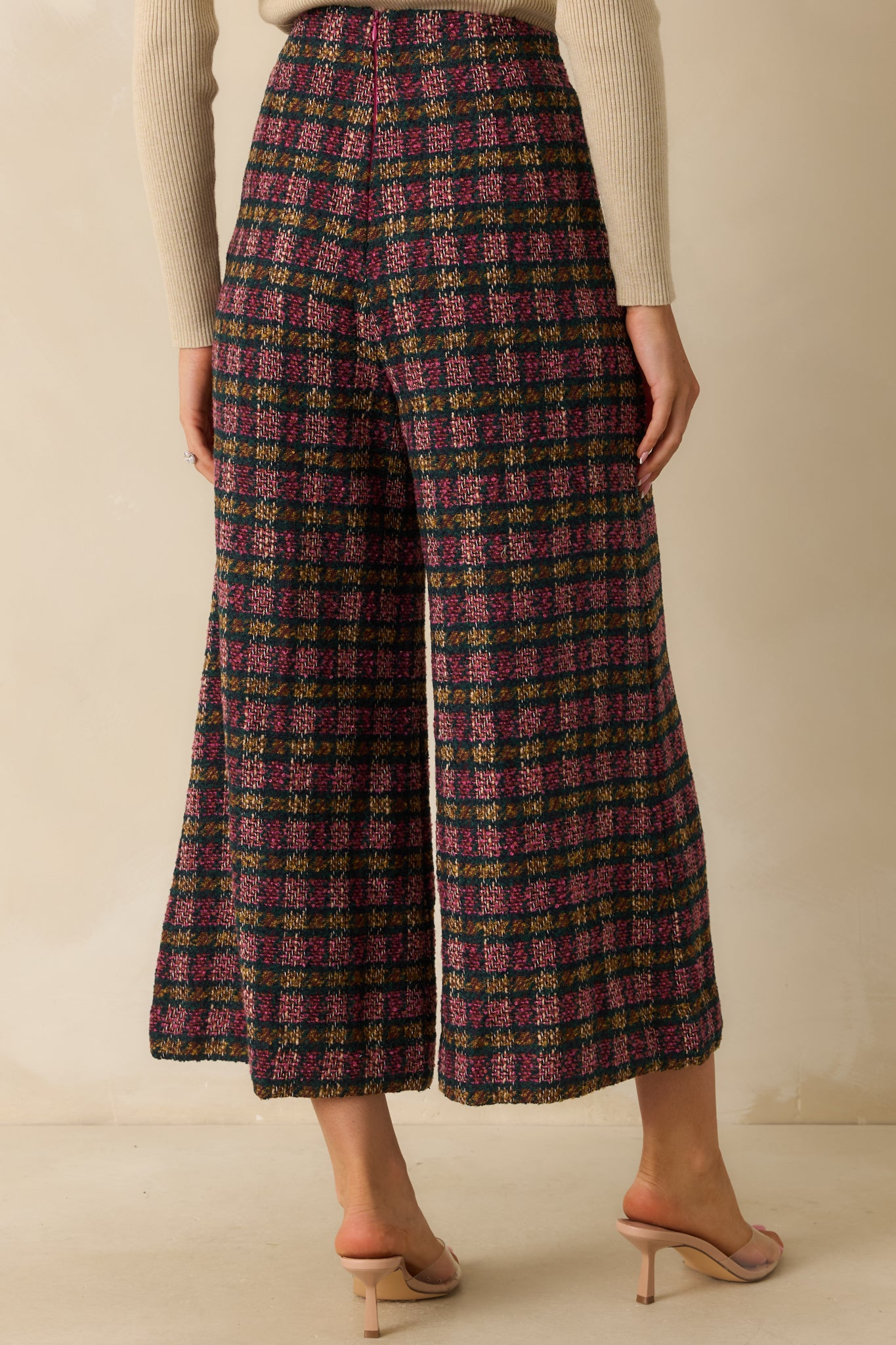 Rear view of the plaid tweed pants showing the concealed back zipper closure and structured wide-leg shape.