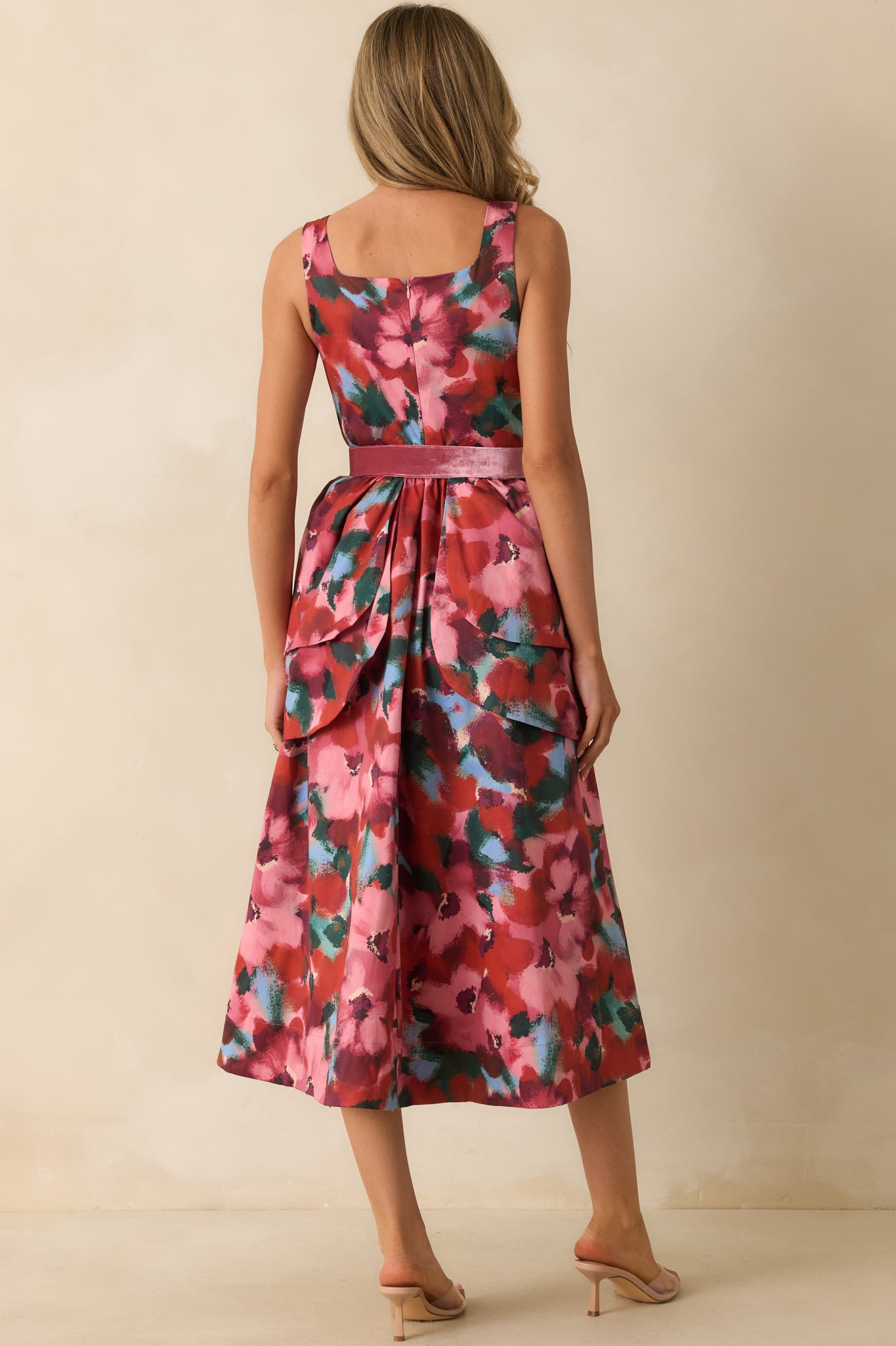 Rear view of the pink watercolor floral midi dress showing the concealed back zipper and layered waist detail.