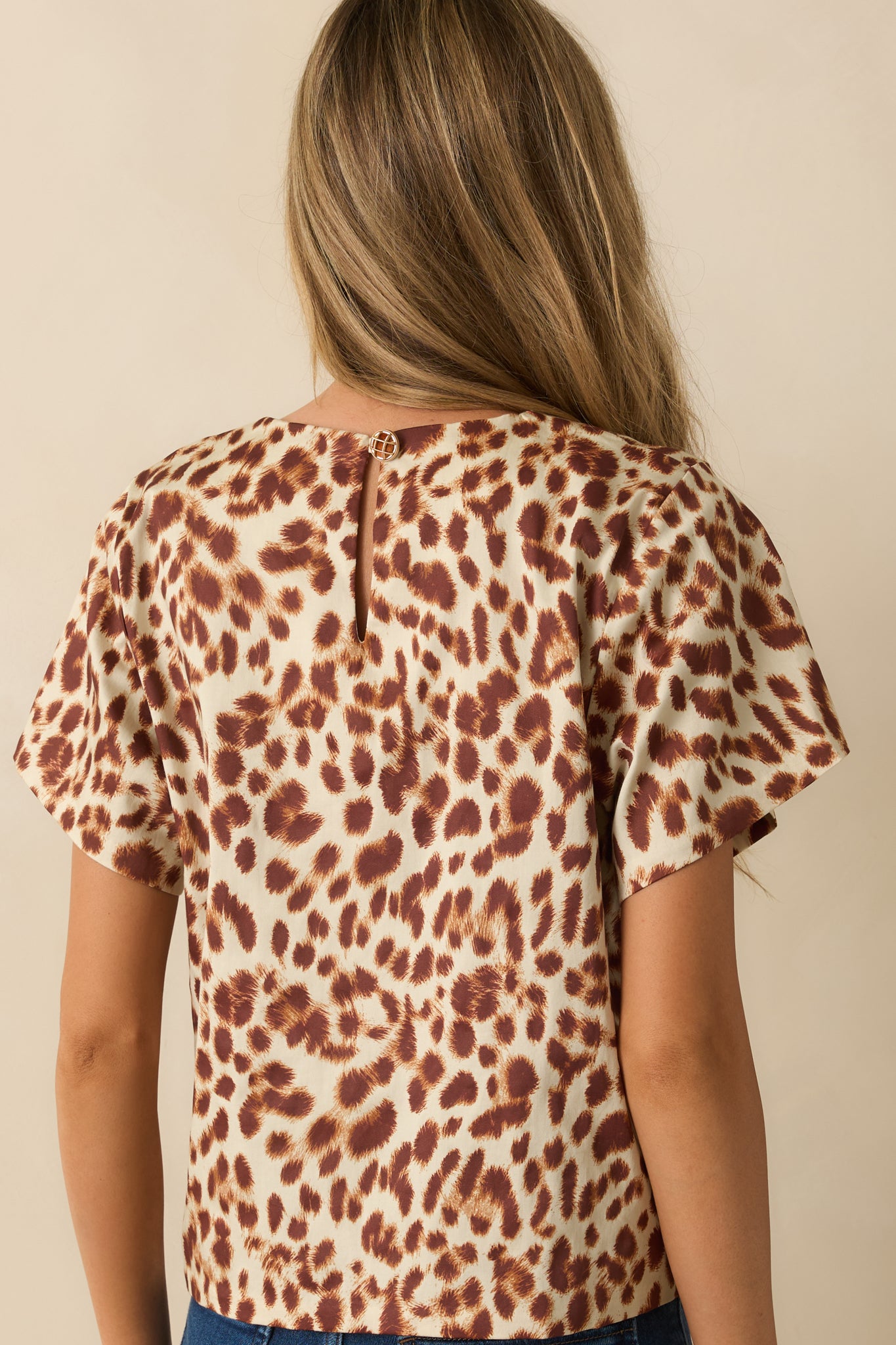 Rear view highlighting the back keyhole button closure and lightweight cotton fabric of the top.