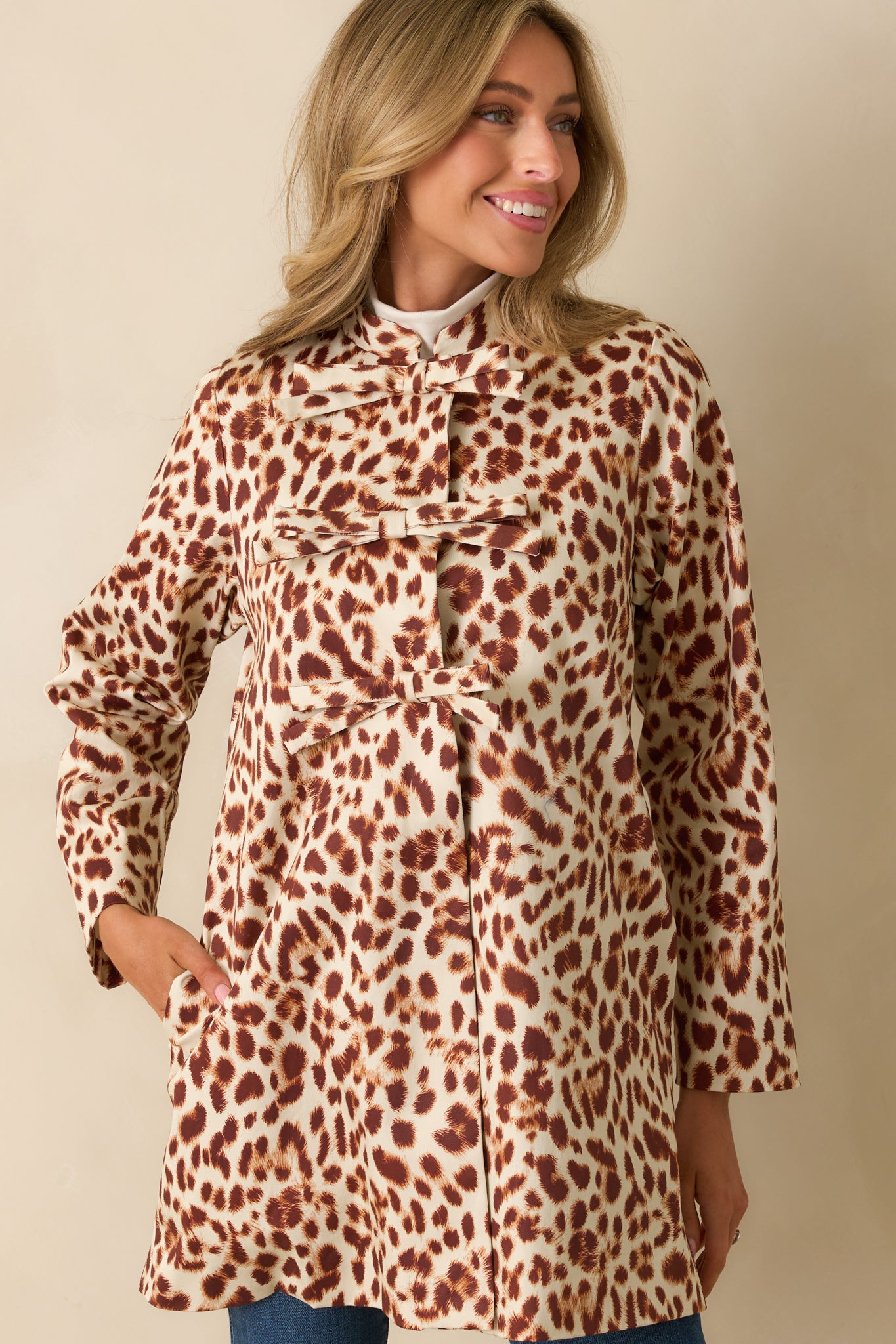 Cropped look showing the functional side seam pockets and straight hemline of the coat