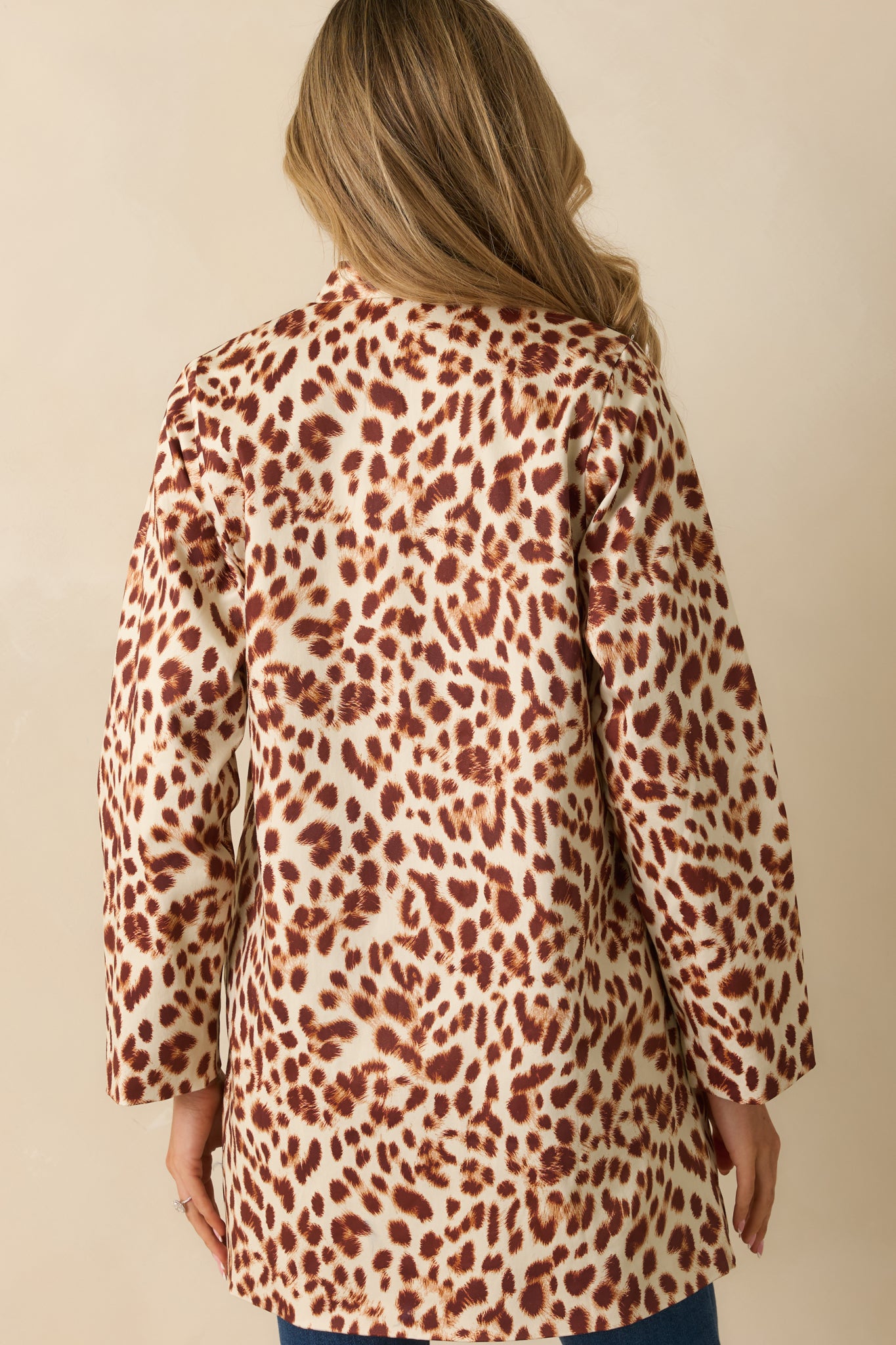 Rear view of the abstract leopard print coat showing the straight hemline and long sleeves.