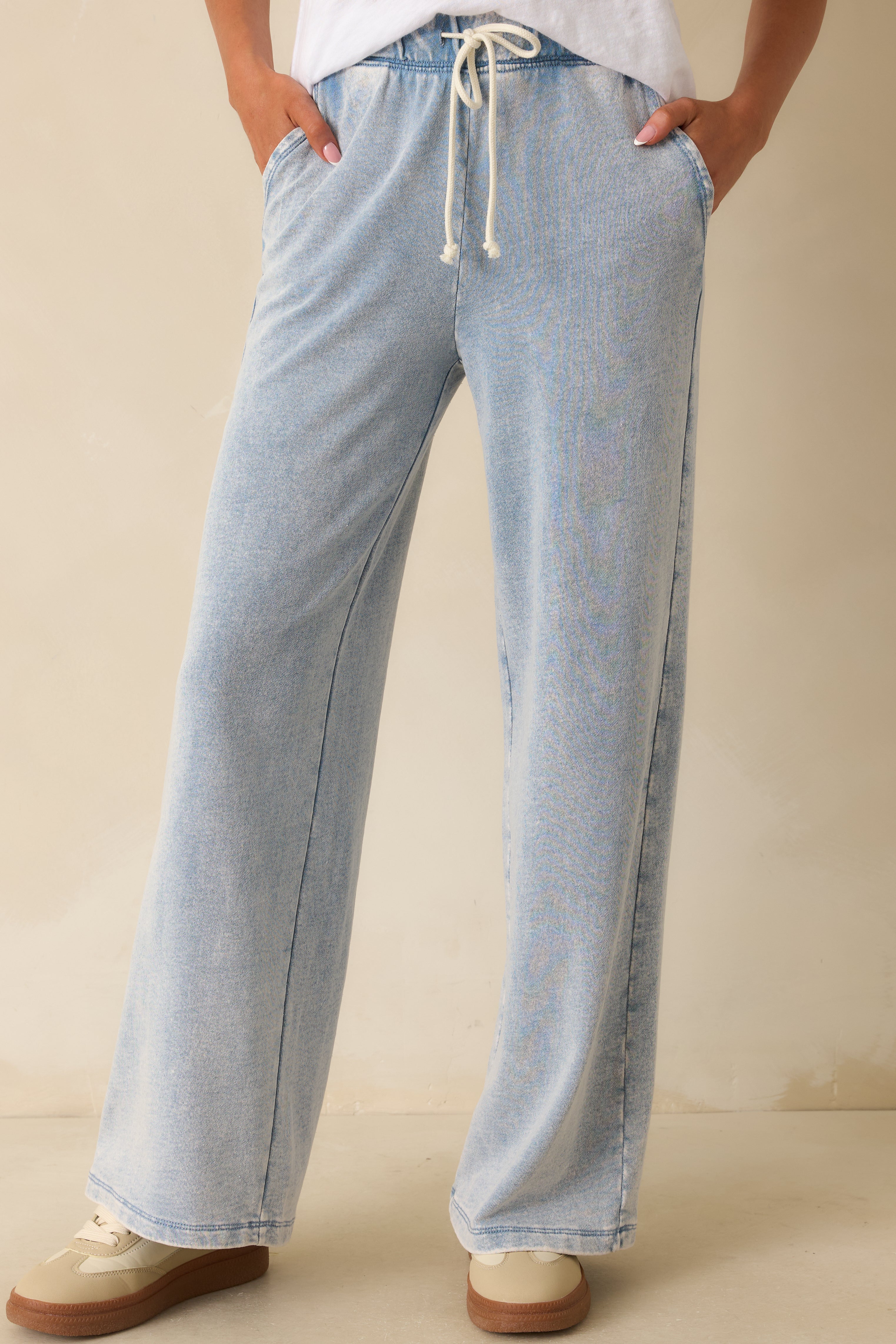 Wide pant legs and front pockets highlighted for a comfortable, everyday look.