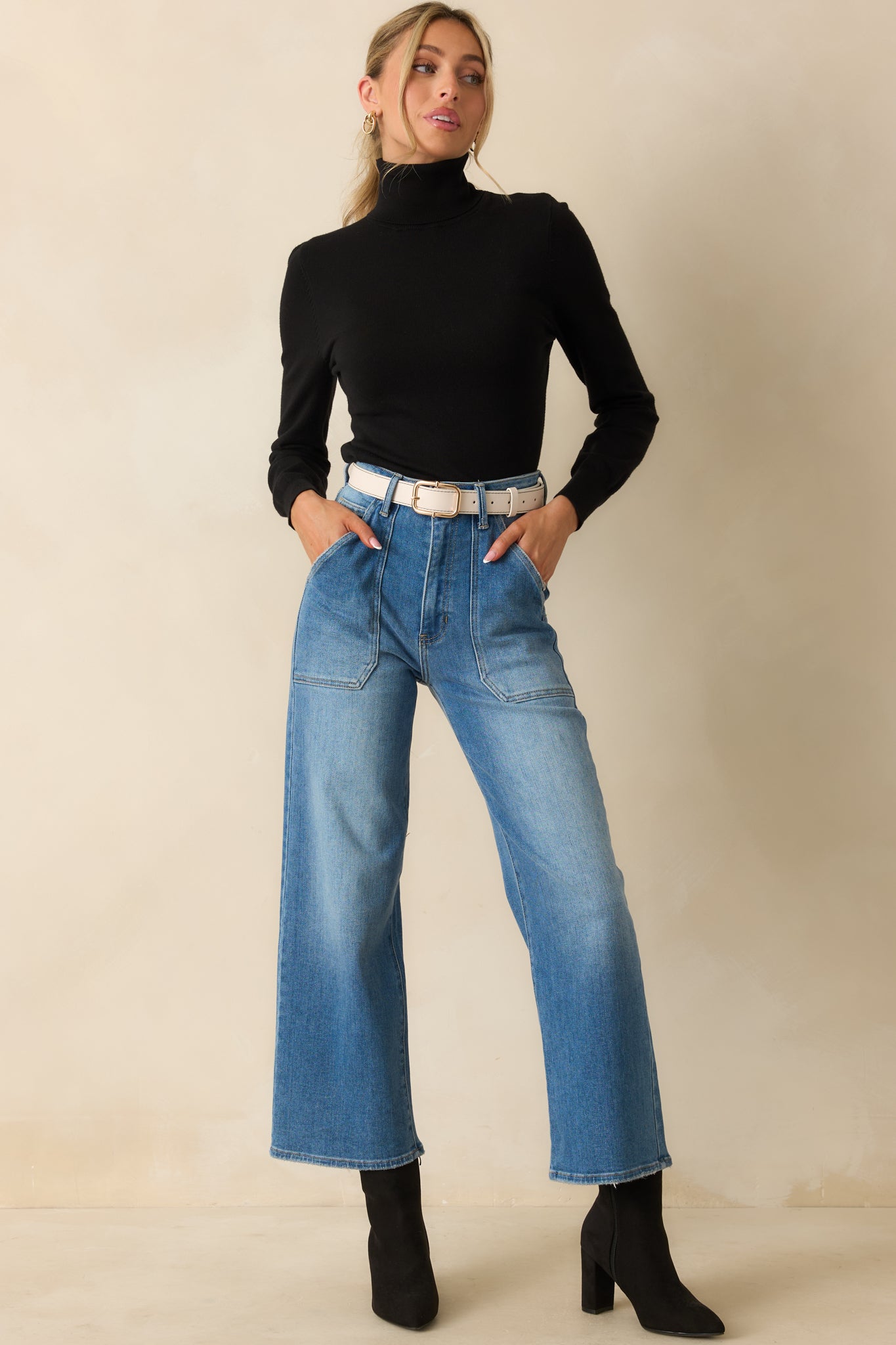 Front view of jeans featuring functional patch pockets, belt loops, and button-zipper closure.