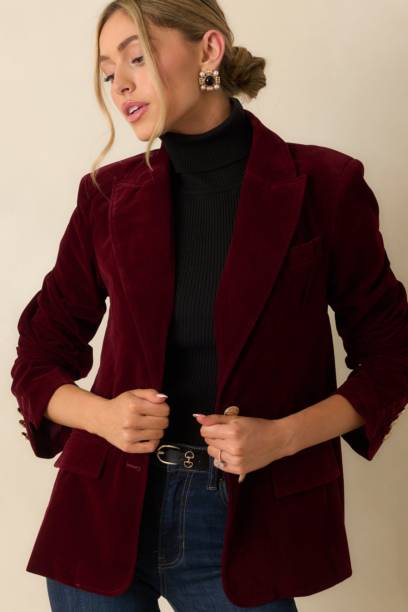 Close view of the notched lapel collar and upper bodice highlighting the soft velvet texture.