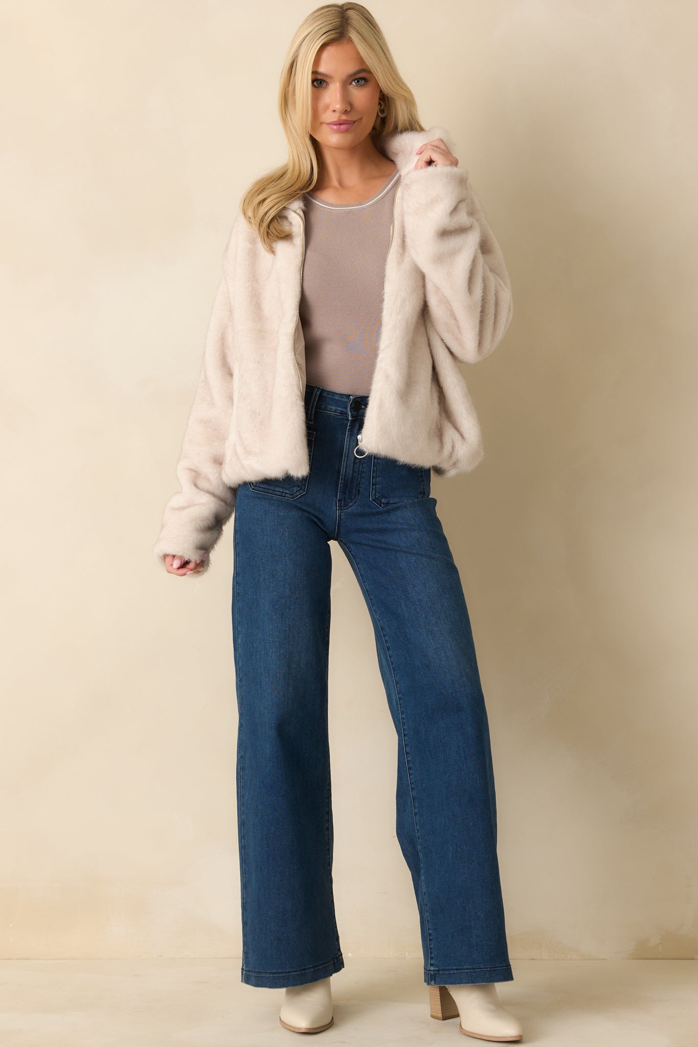 Front view of the ivory zip-up jacket with plush faux fur texture, relaxed fit, and collared neckline.