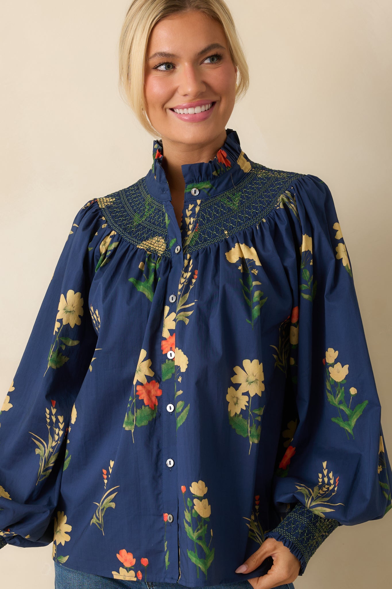 Detail of the smocked yoke with green embroidery and floral pattern