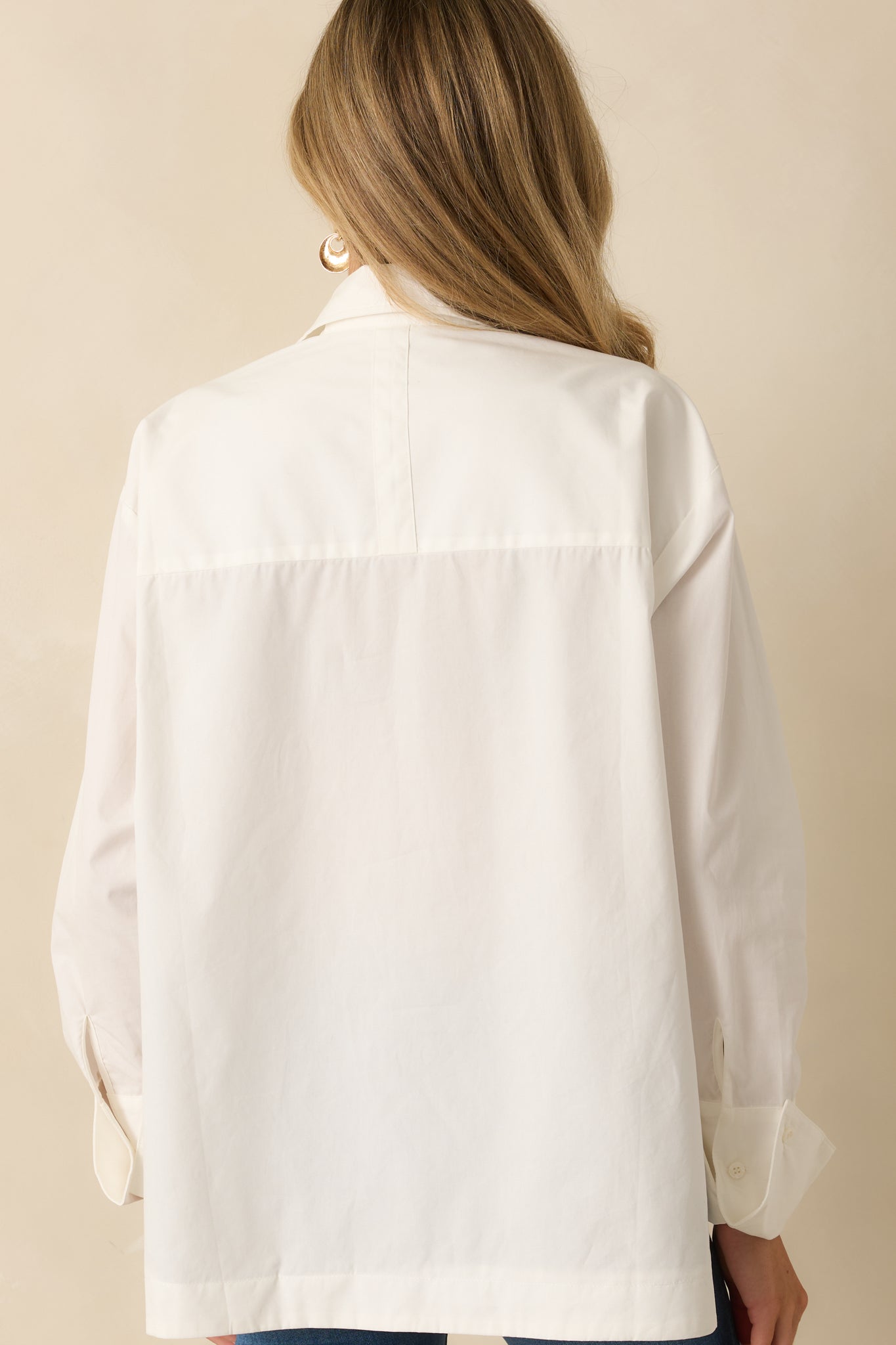 Rear view of the blouse displaying the smooth back and long sleeves.